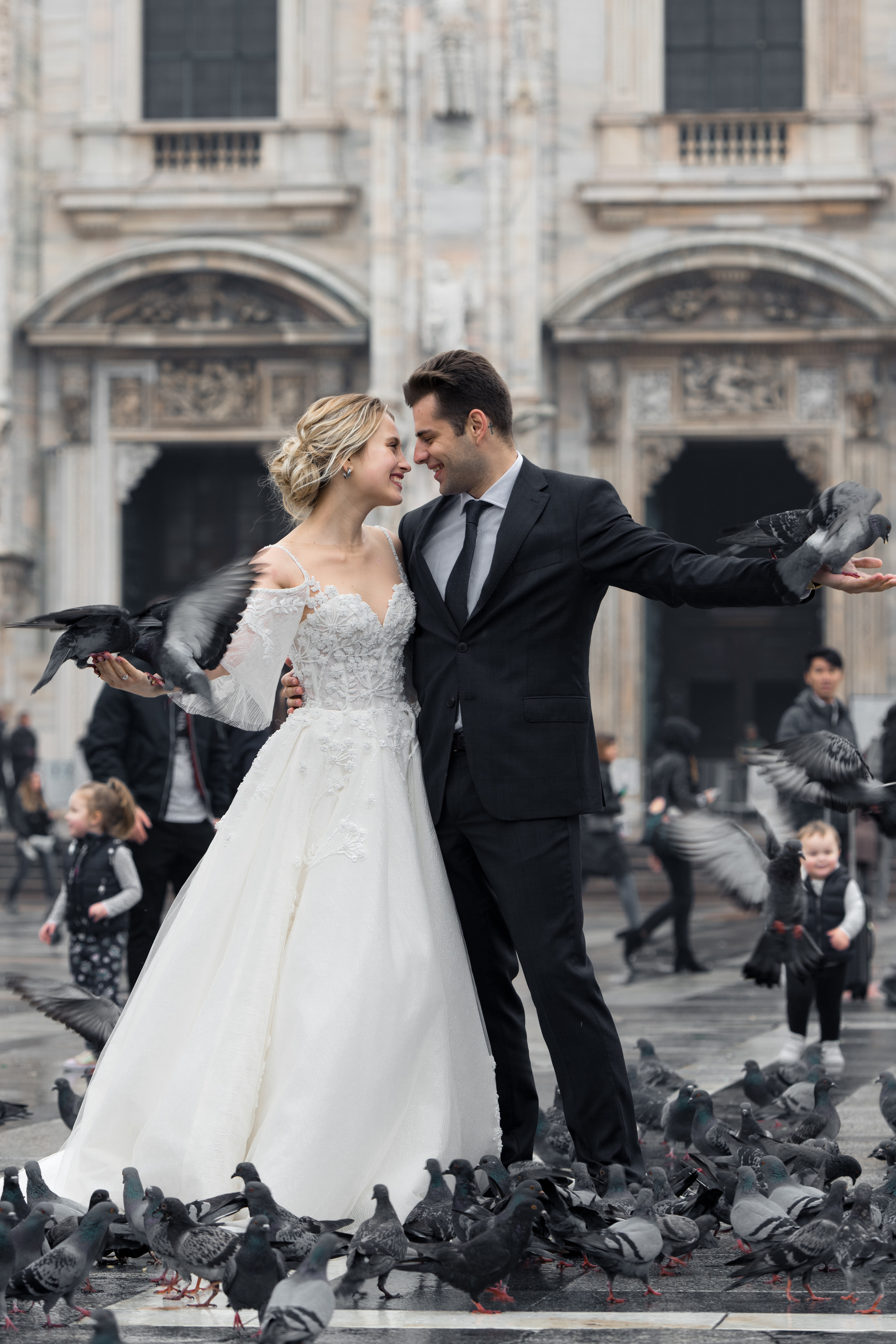 A beautiful wedding couple in Milan, Italy near Milan Cathedral with flying doves. Milano Duomo wedding
