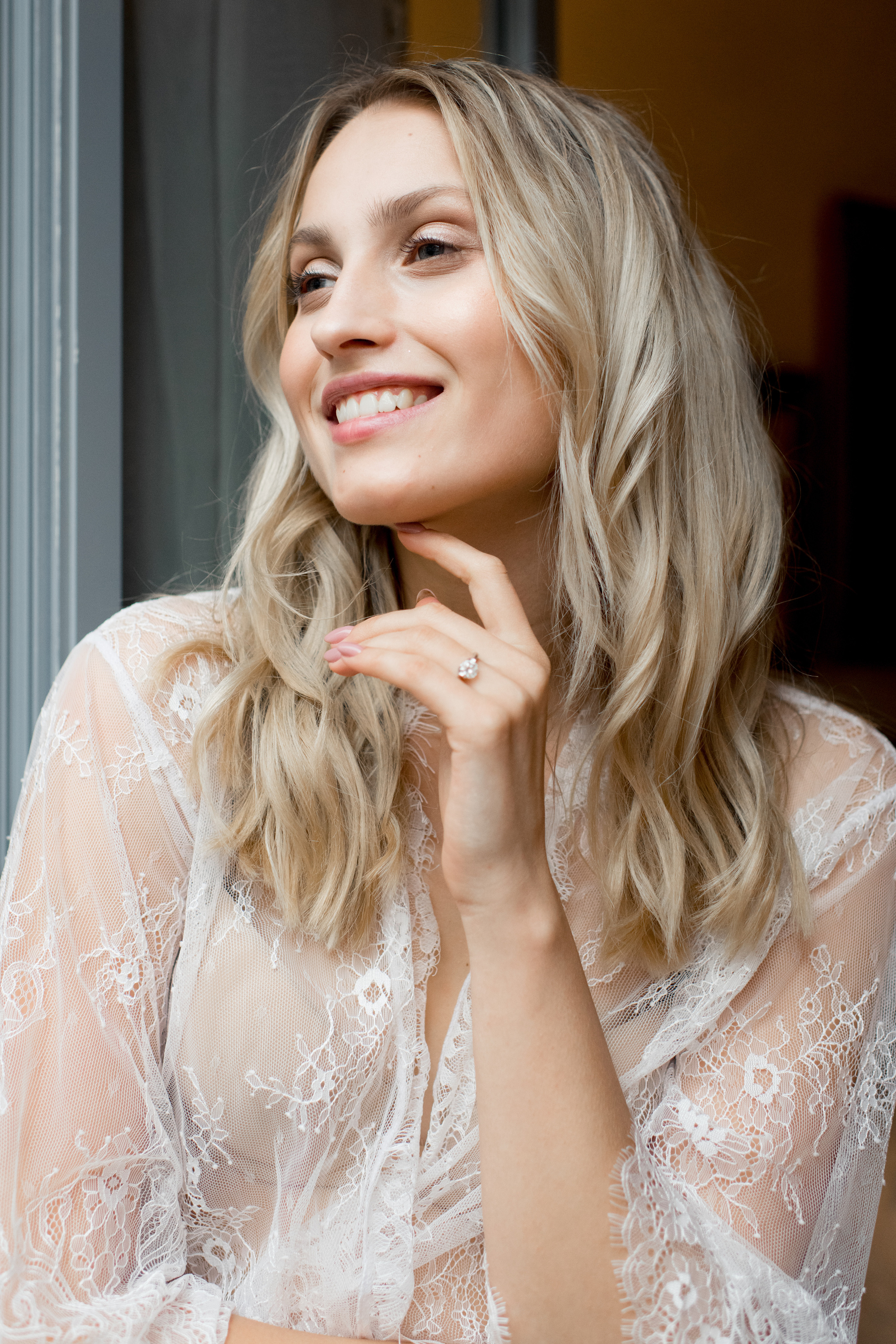 A happy and beautiful bride in white lingerie is waiting for her fiance in Milan, Italy