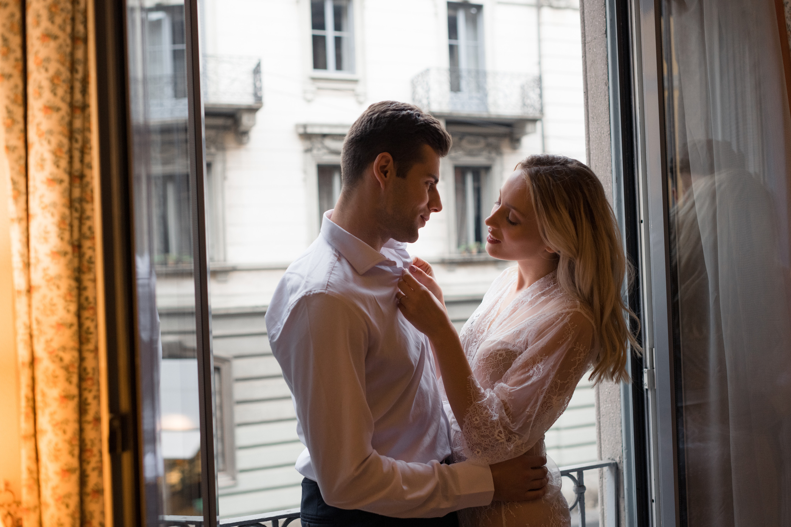 A bride and fiance looking to each other and laughing in Milan, Italy. A romantic wedding couple