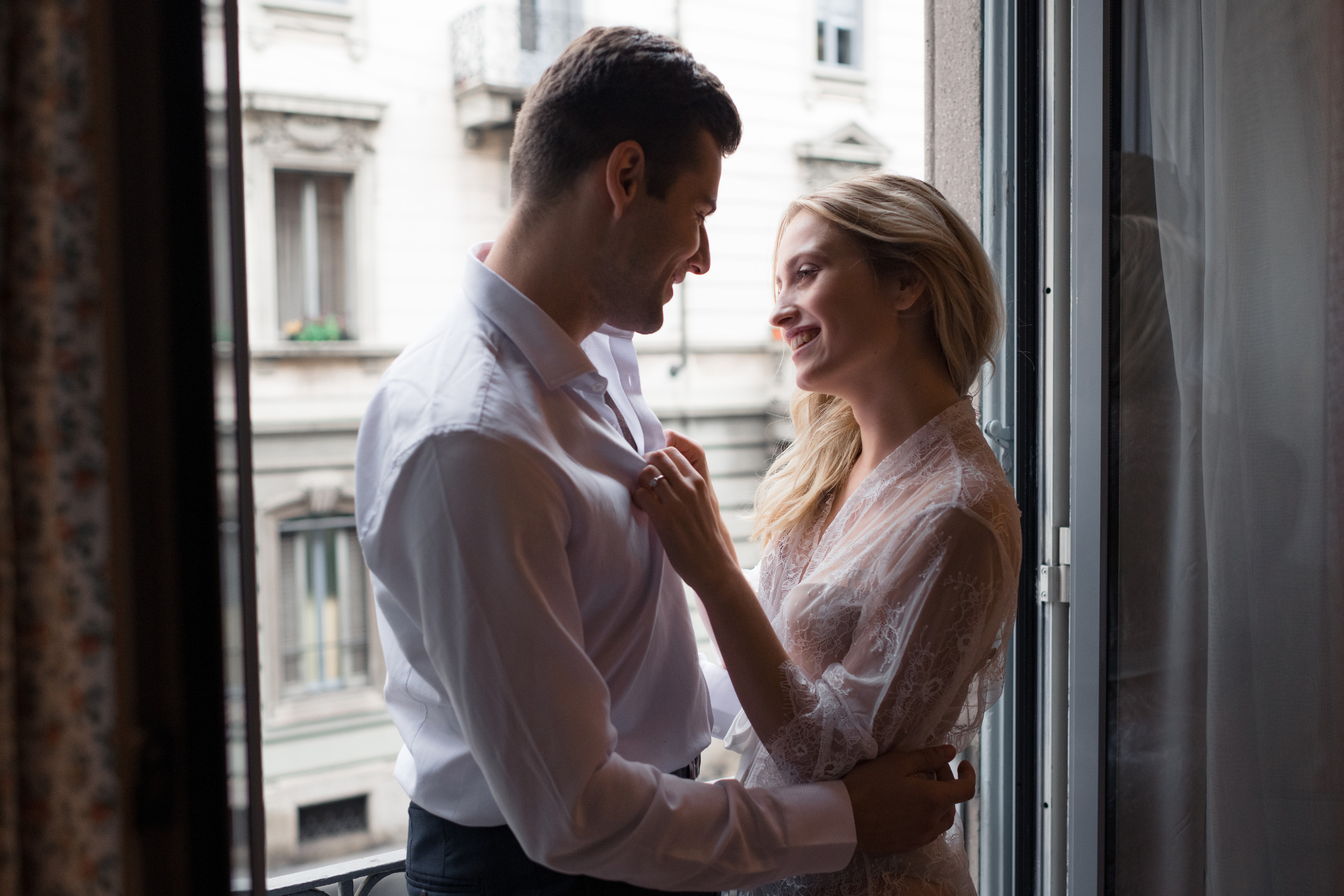 A bride and fiance looking to each other and laughing in Milan, Italy. A romantic wedding couple