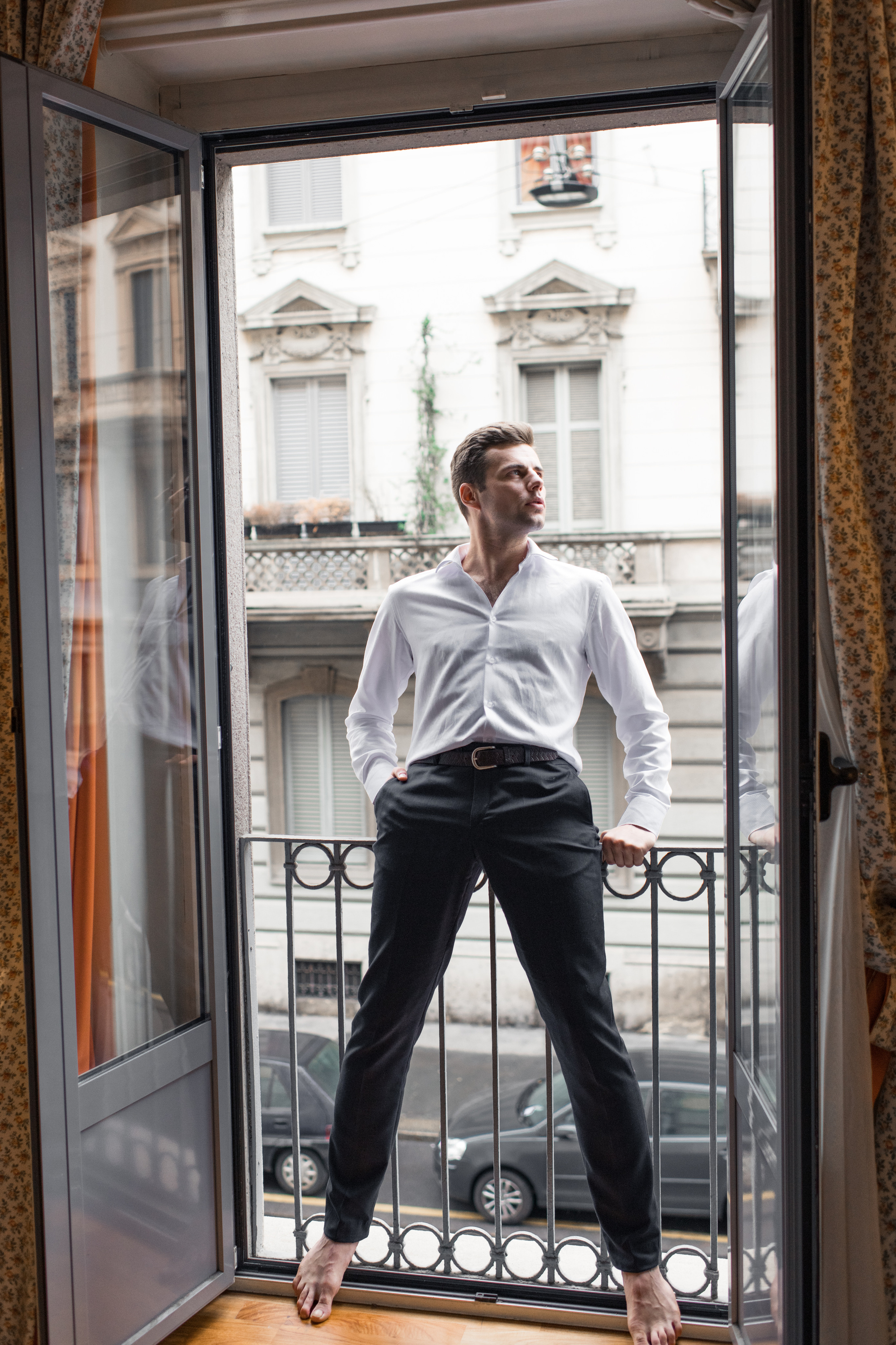 A fiance is waiting on the balcony for his bride in Milan, Italy