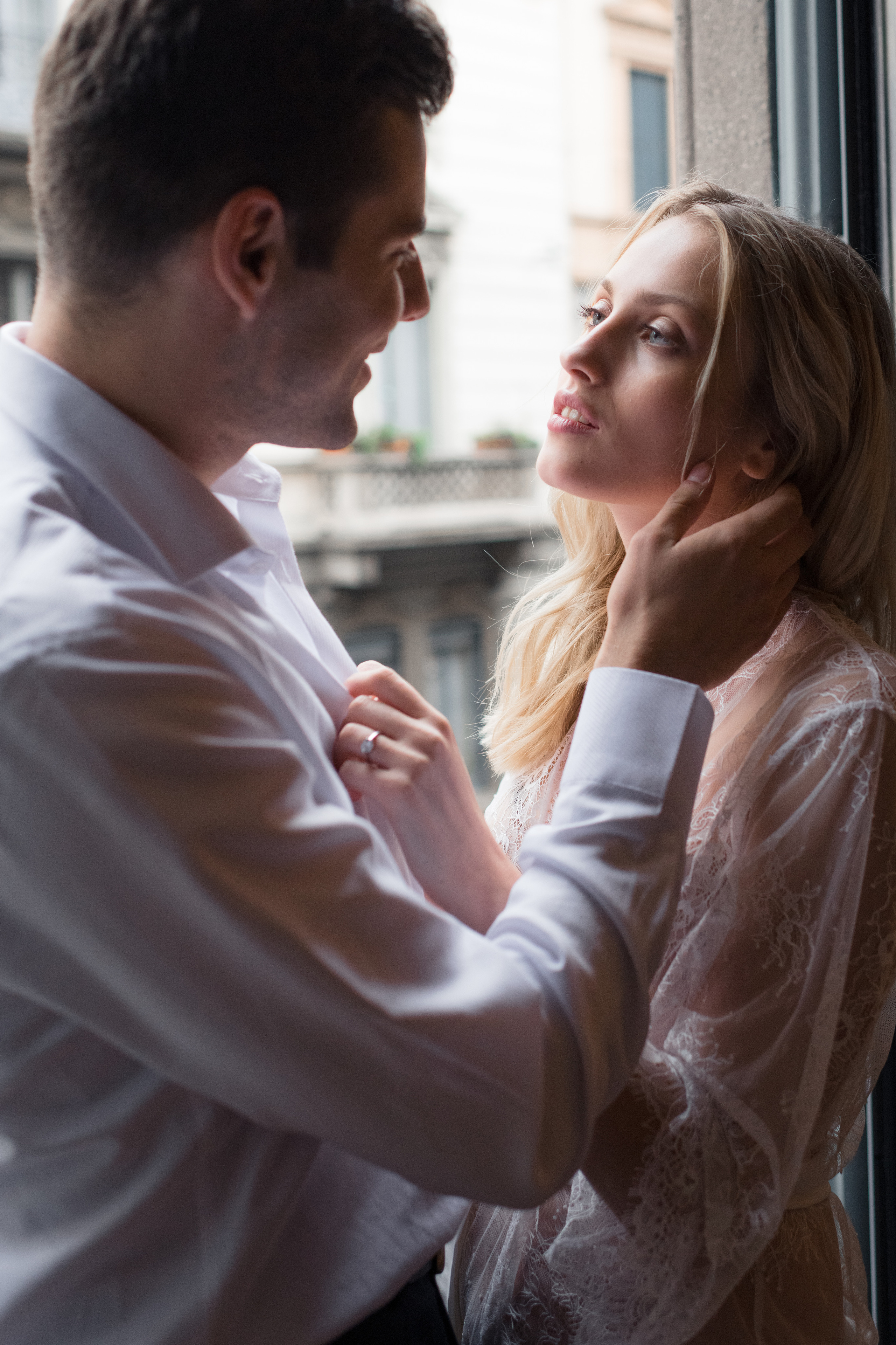 A bride and fiance looking to each other and laughing in Milan, Italy. A romantic wedding couple