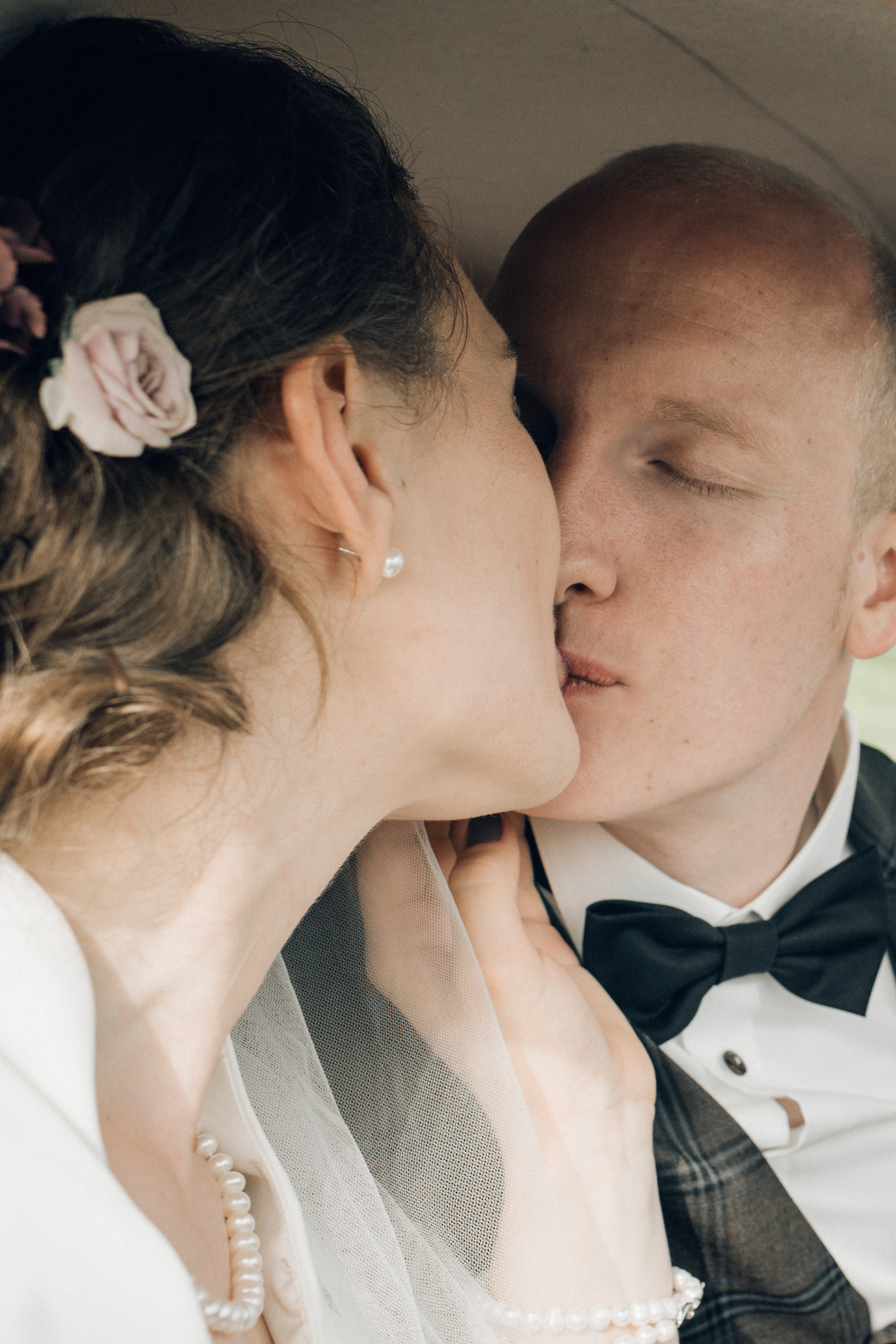 A wedding couple kisses each other