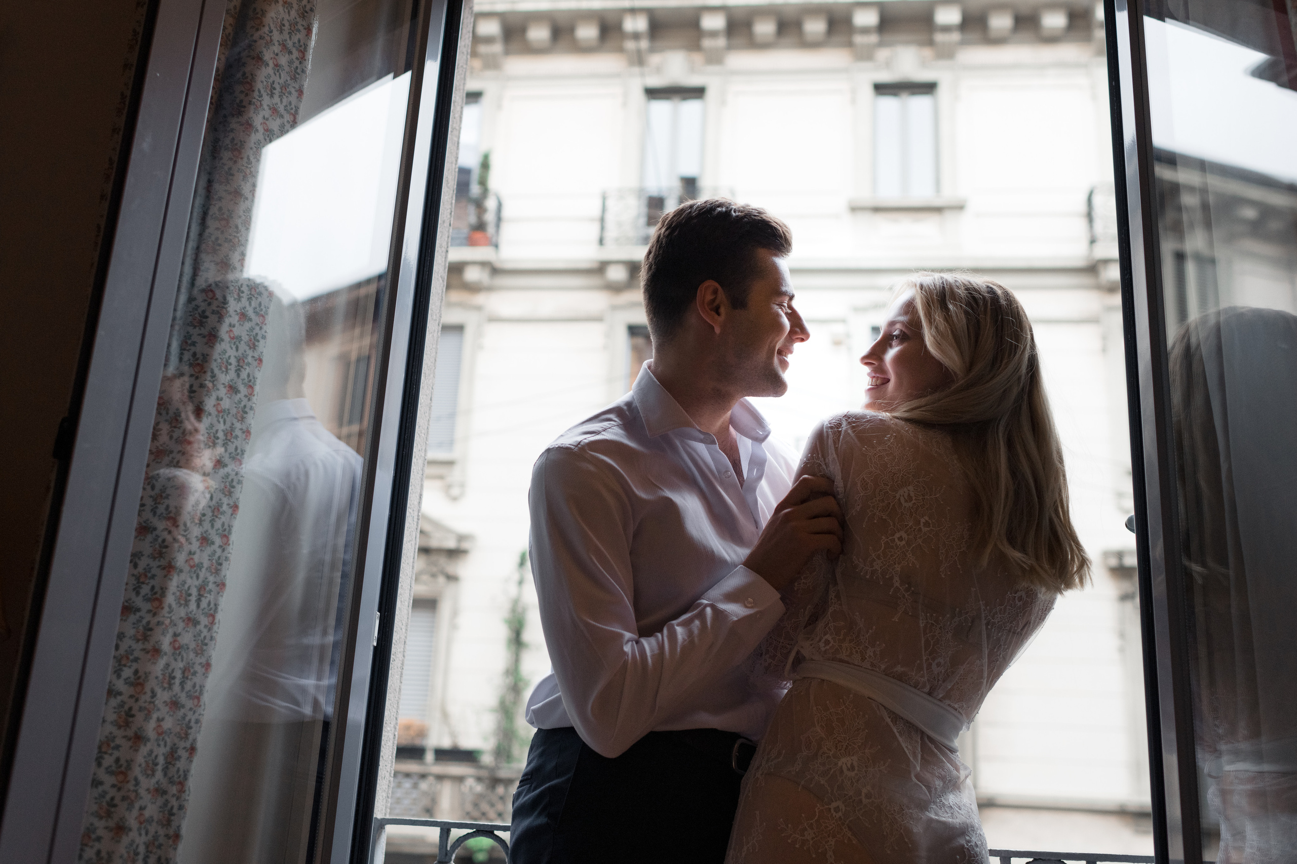 A bride and fiance looking to each other and laughing in Milan, Italy. A romantic wedding couple