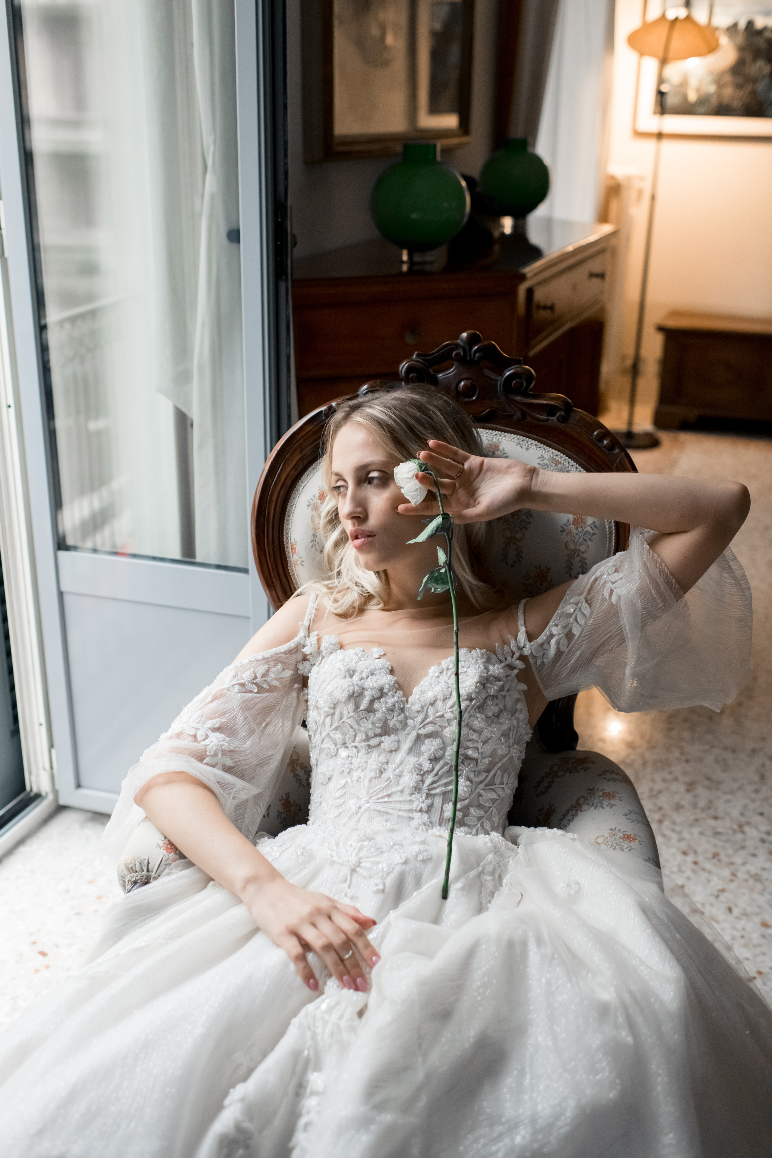 A beautiful bride in a wedding dress waiting for her fiance with a rose in Milan, Italy
