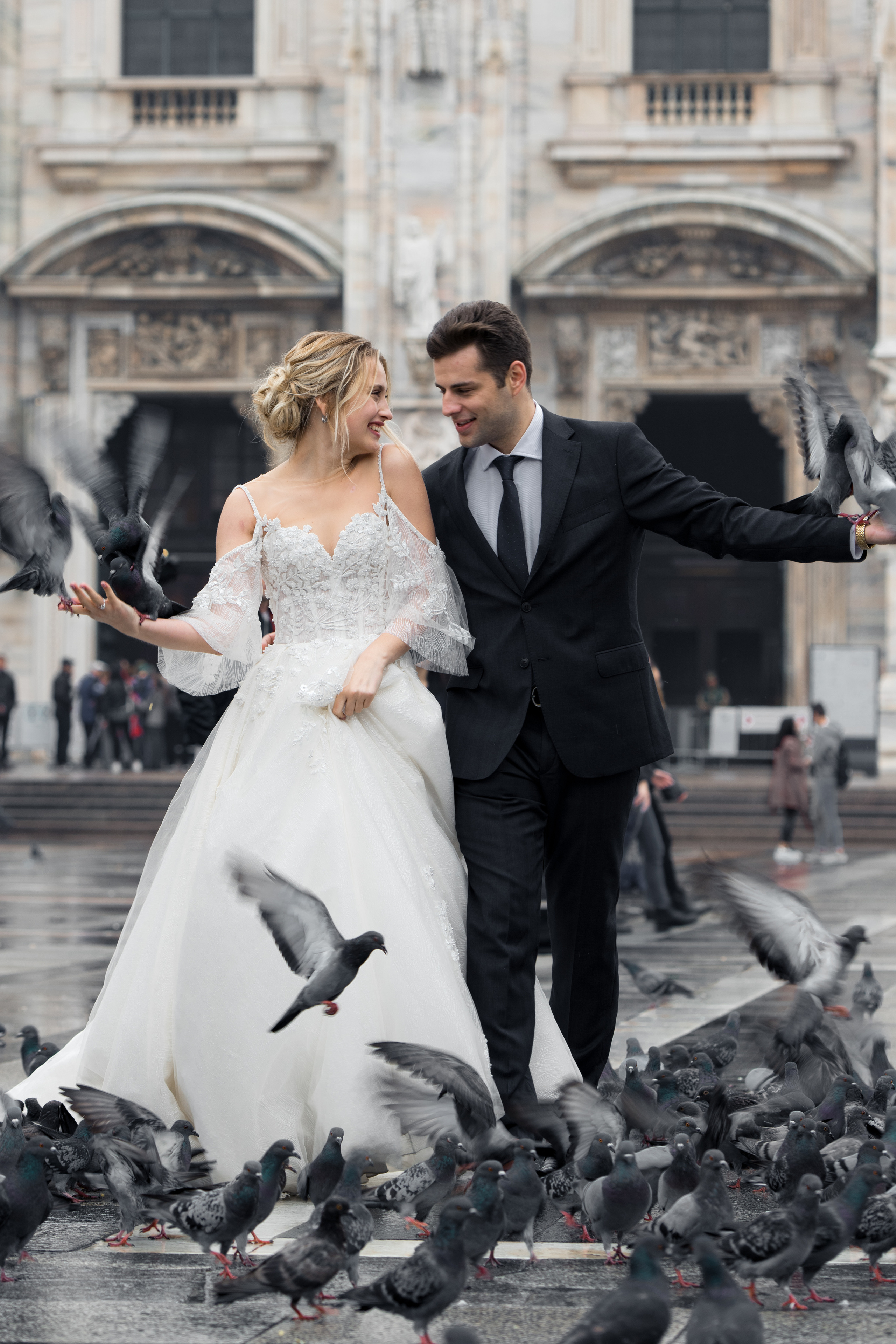 A beautiful wedding couple in Milan, Italy near Milan Cathedral with flying doves. Milano Duomo wedding