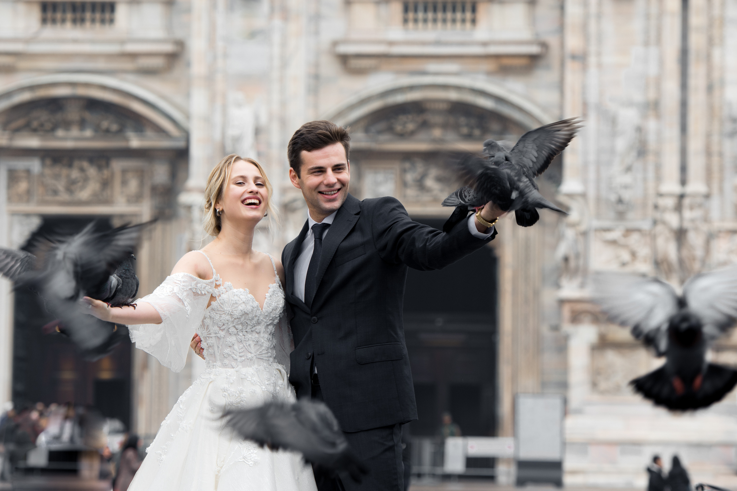 A beautiful wedding couple in Milan, Italy near Milan Cathedral with flying doves. Milano Duomo wedding