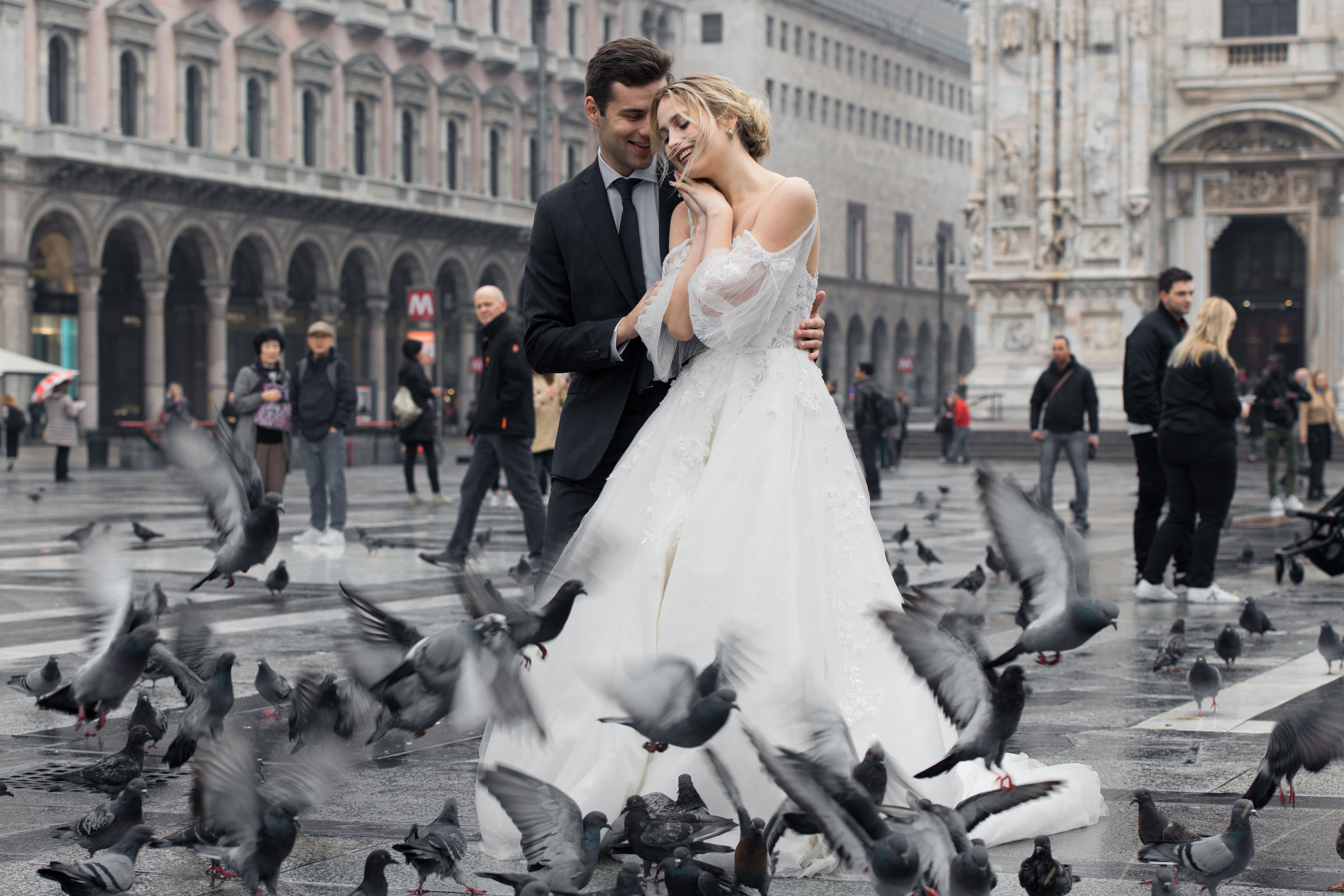 A beautiful wedding couple in Milan, Italy near Milan Cathedral with flying doves. Milano Duomo wedding