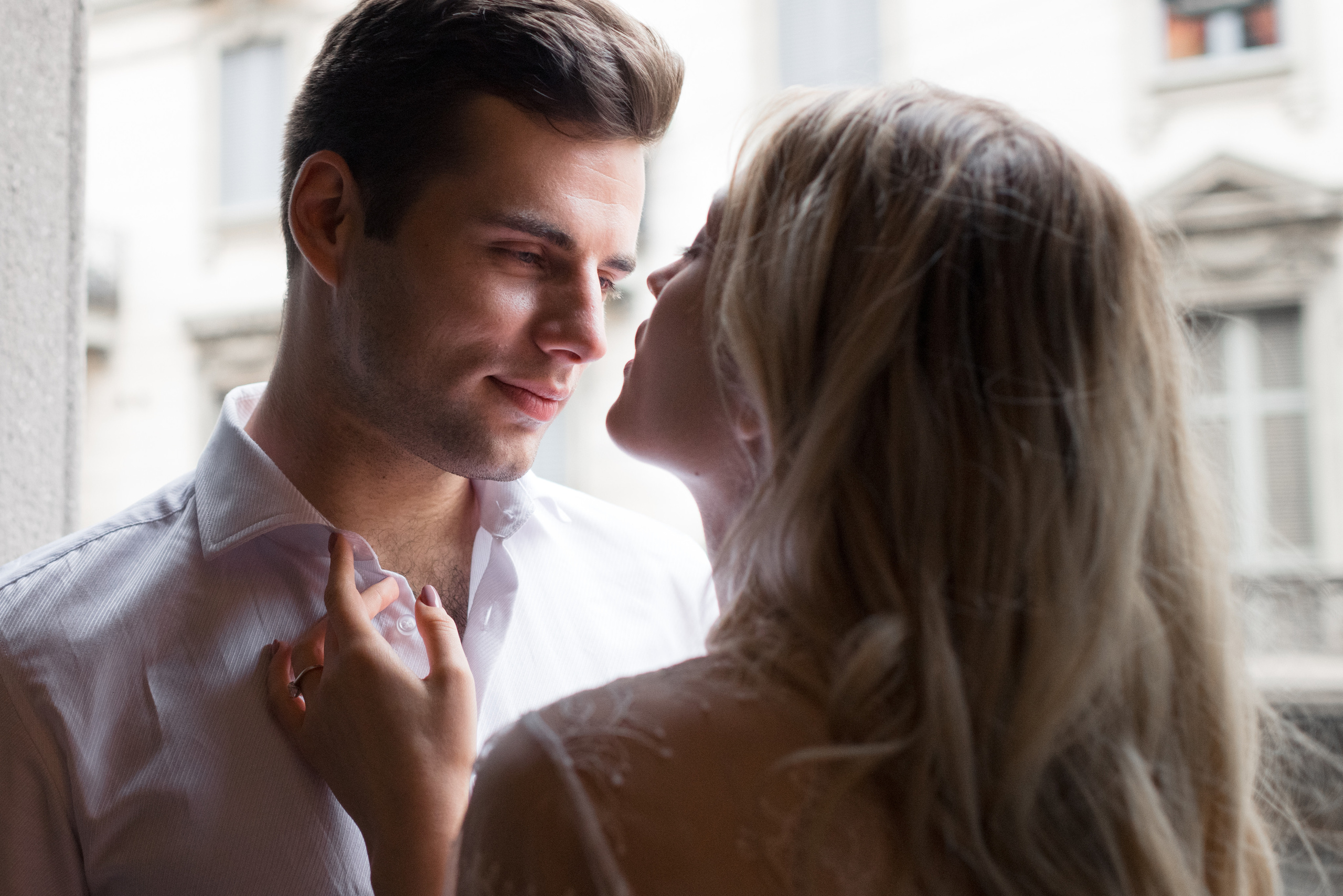 A bride and fiance looking to each other and laughing in Milan, Italy. A romantic wedding couple