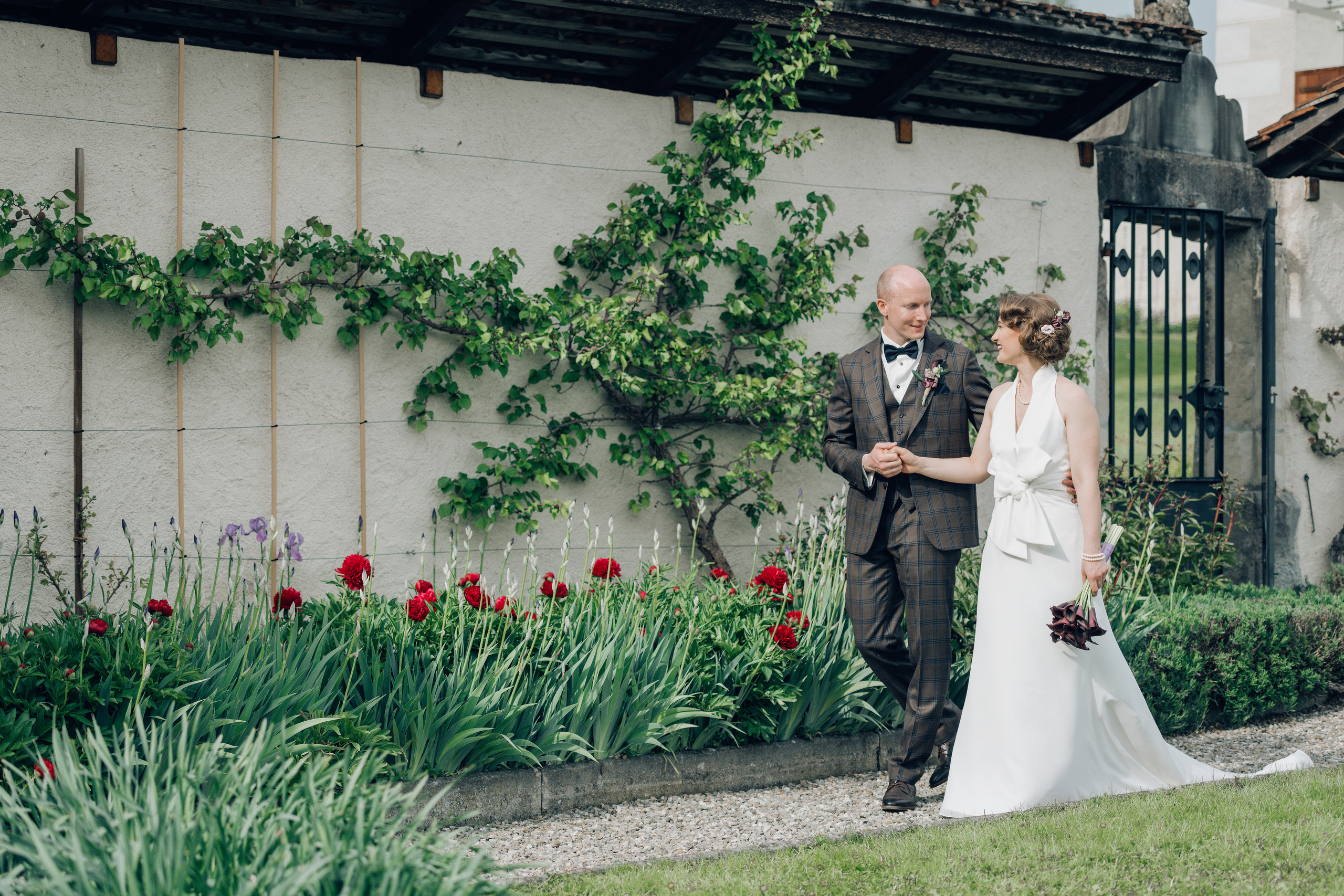 A wedding couple going through the garden