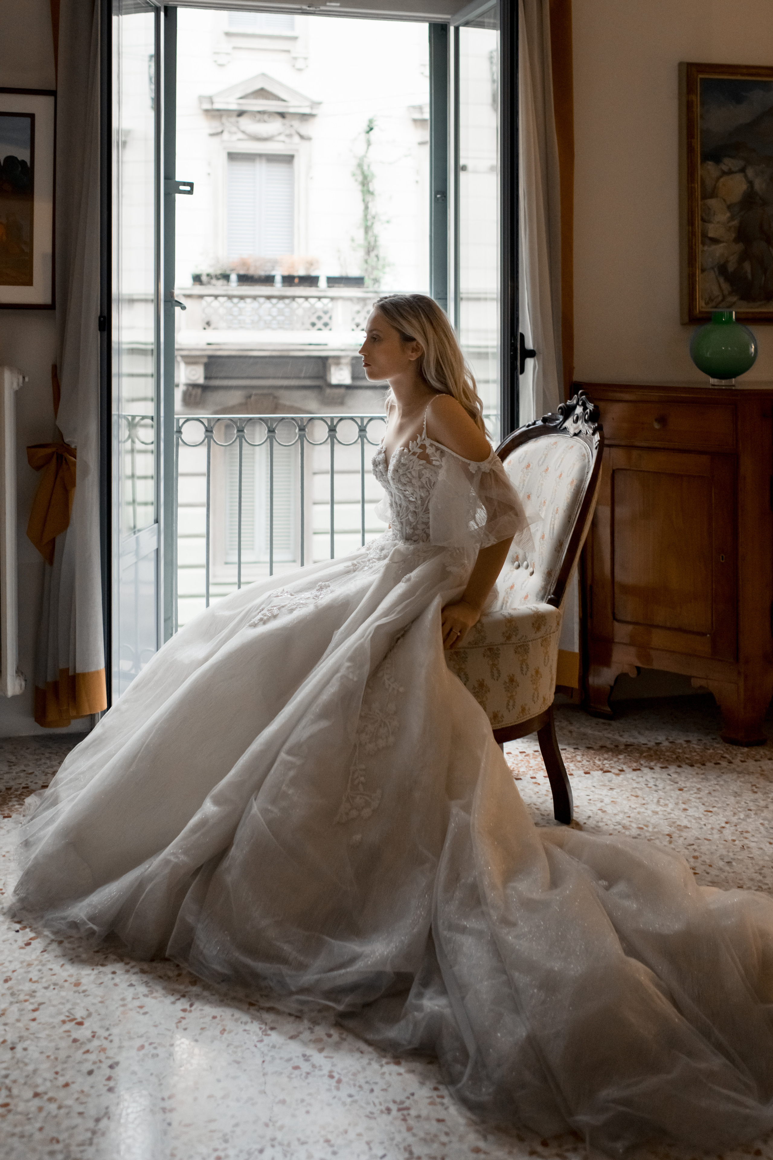 A beautiful bride in a wedding dress waiting for her fiance with a rose in Milan, Italy