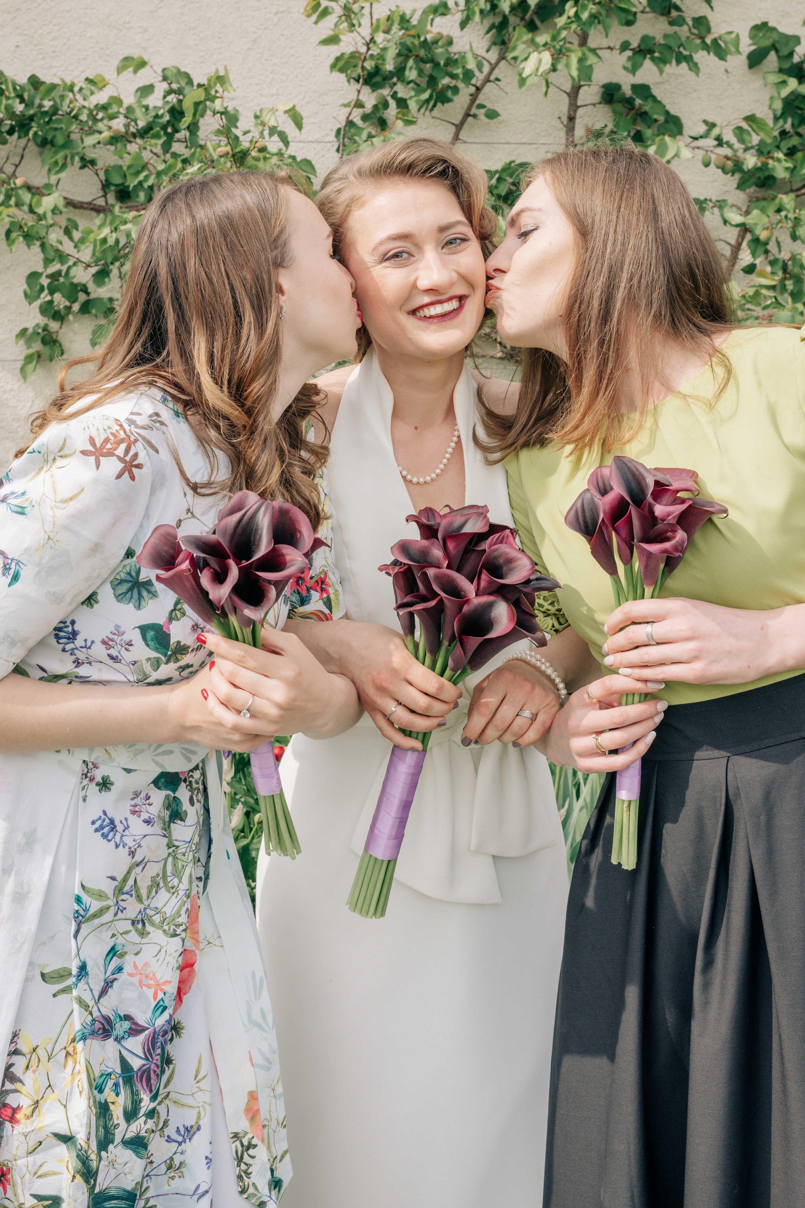Bride's friends in beautiful dresses with flowers
