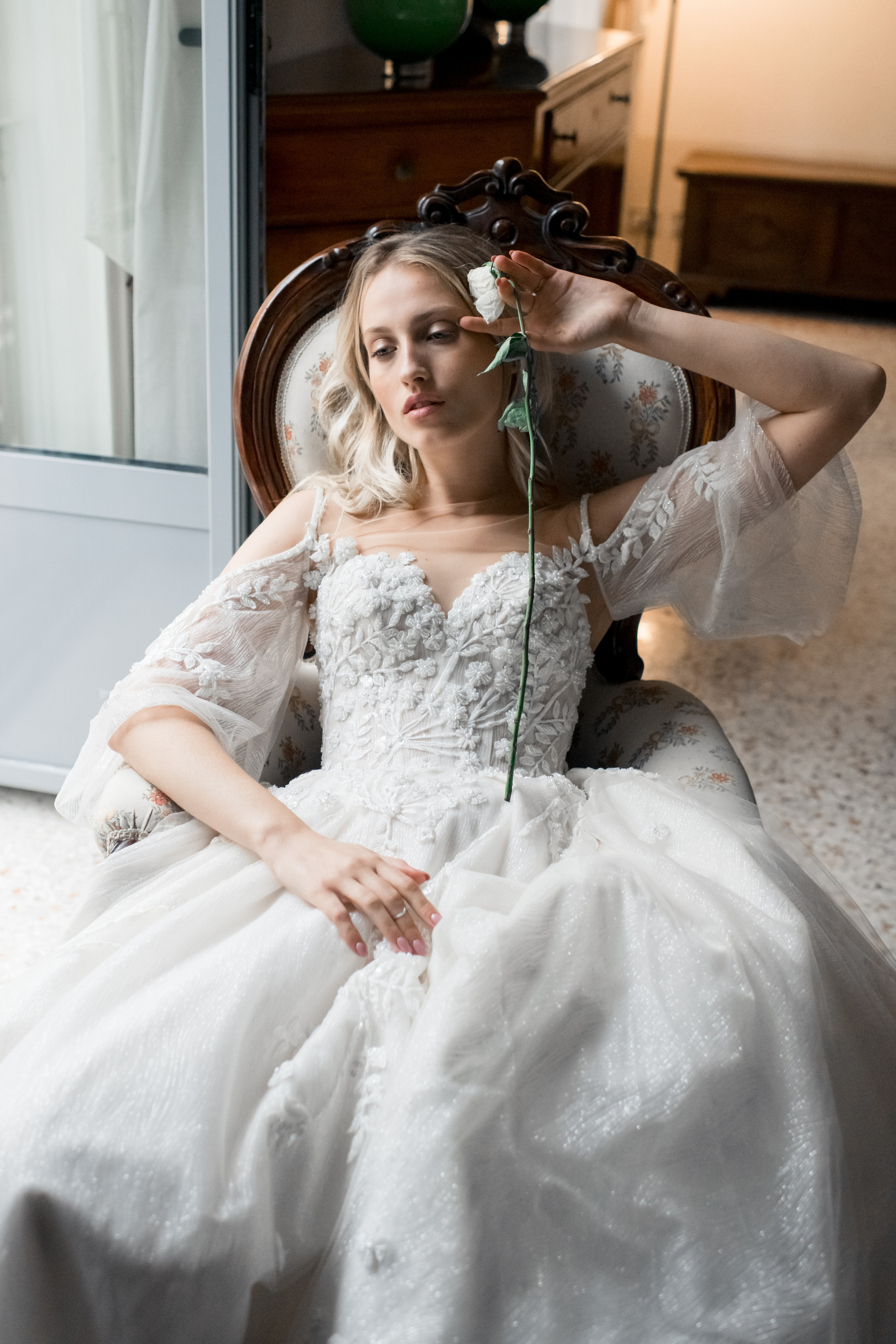 A beautiful bride in a wedding dress waiting for her fiance with a rose in Milan, Italy