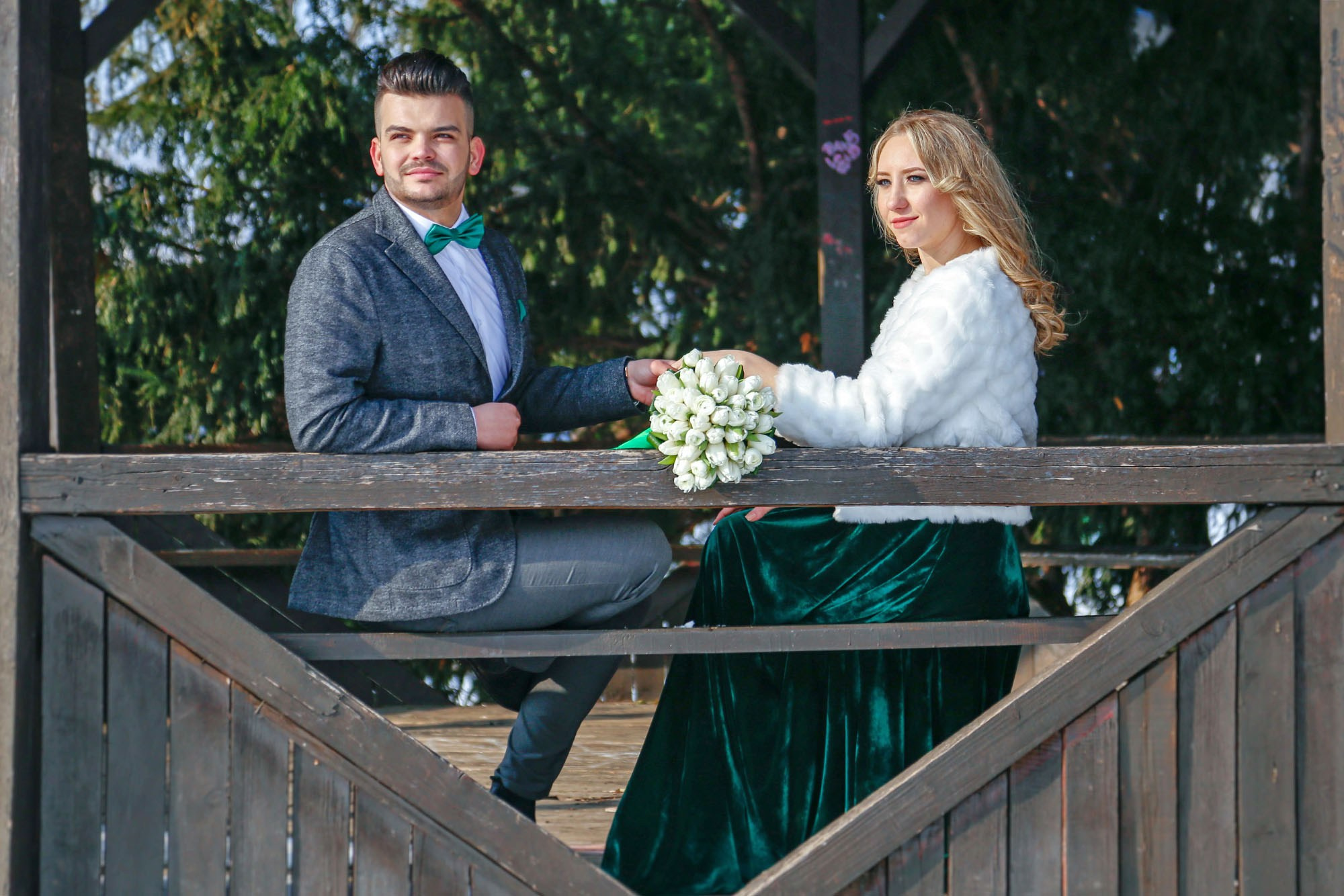 Romantic portrait of the newlyweds embracing inside the gazebo, highlighting the elegant details of their wedding attire.