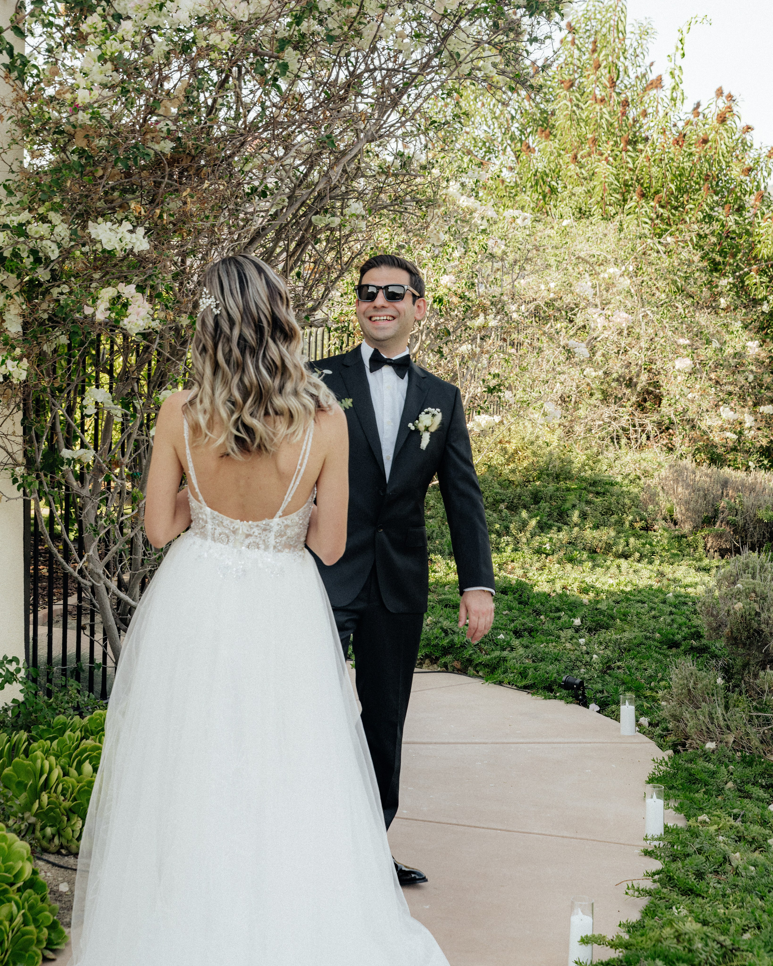 Bride and groom holding hands walking outdoors during wedding