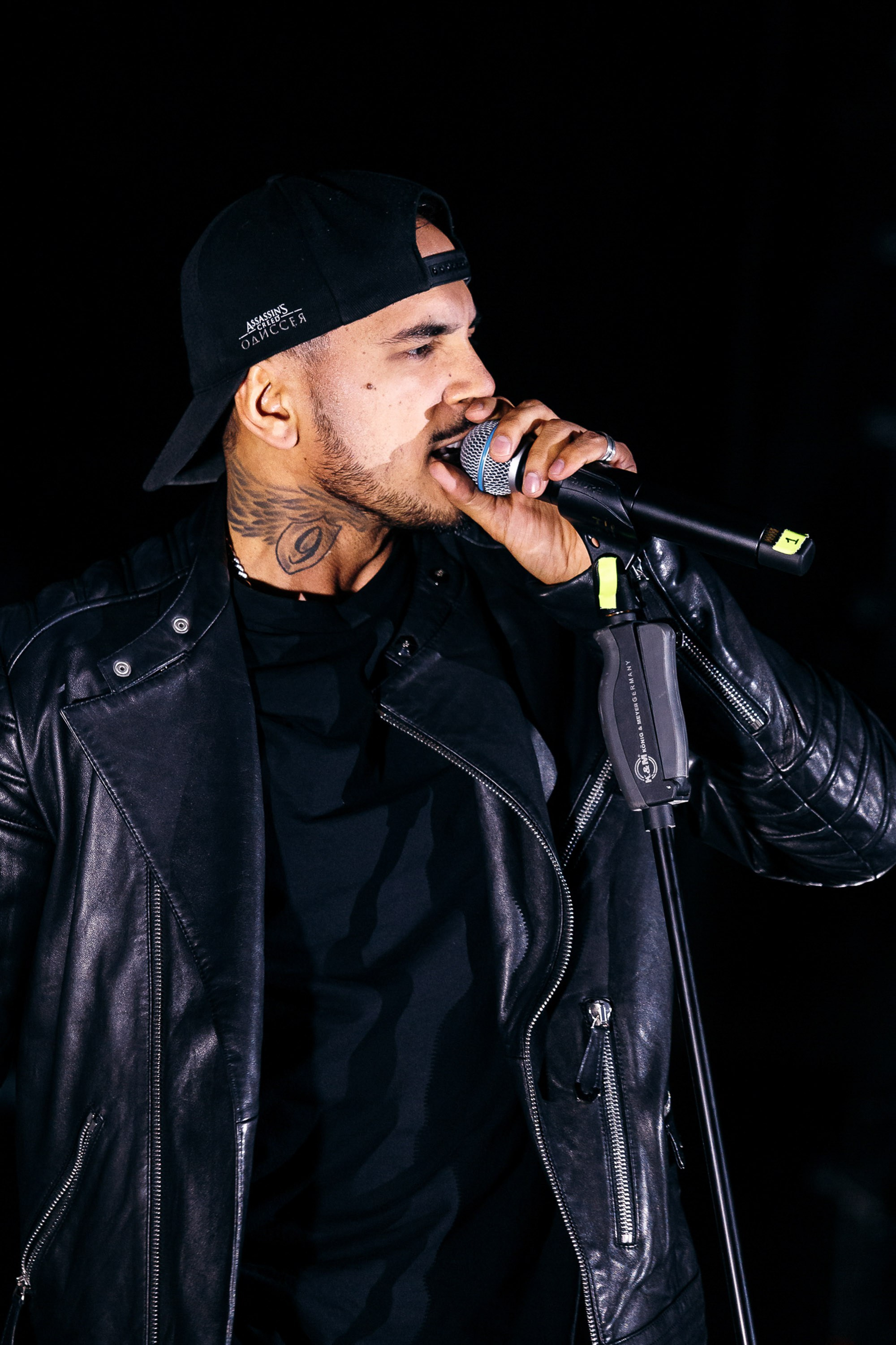 Male rapper performing in black outfit