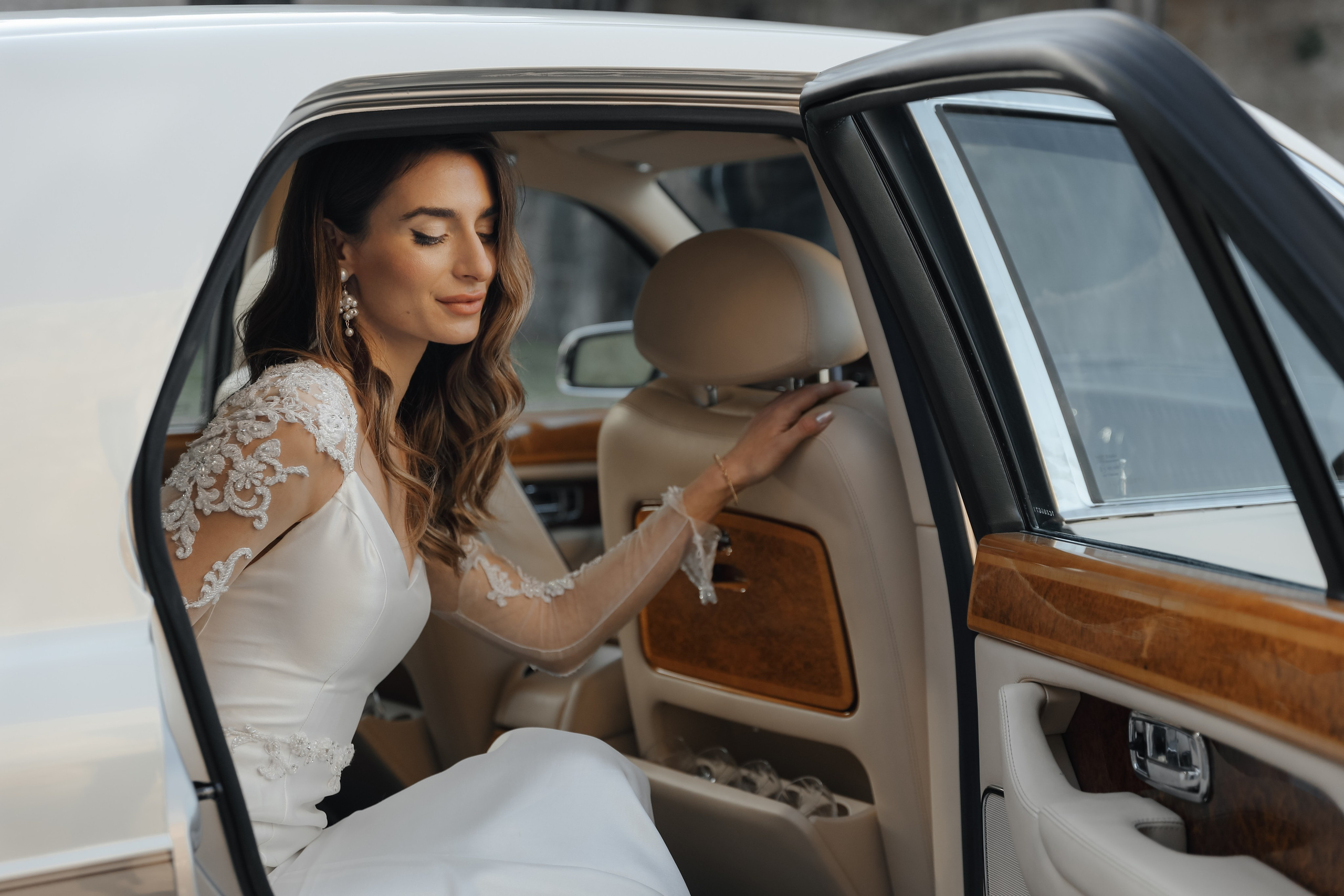 A portrait of a beautiful bride  in Rolls Royce in old town of Rhodes island, Greece