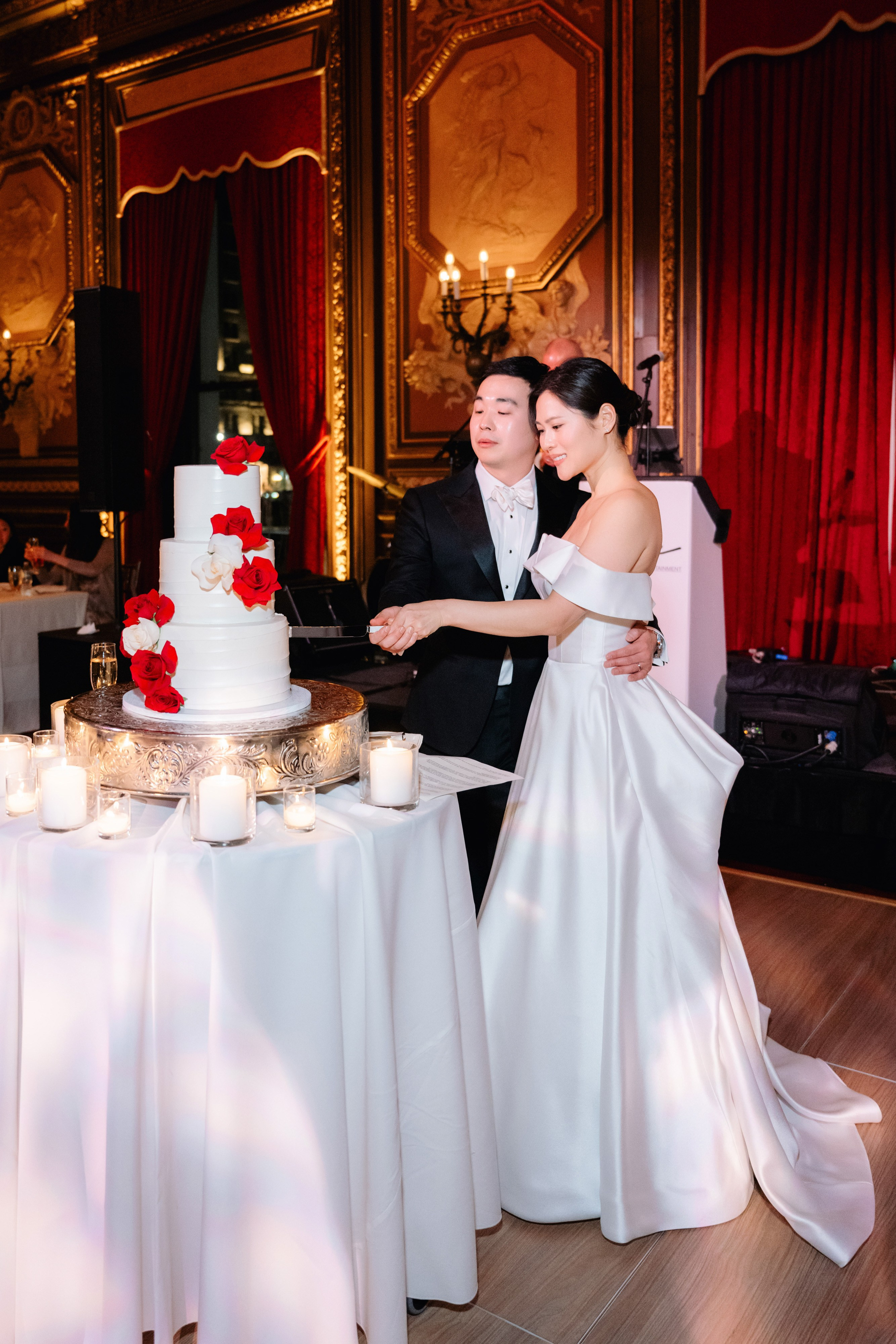 a bride and groom cutting their wedding cake