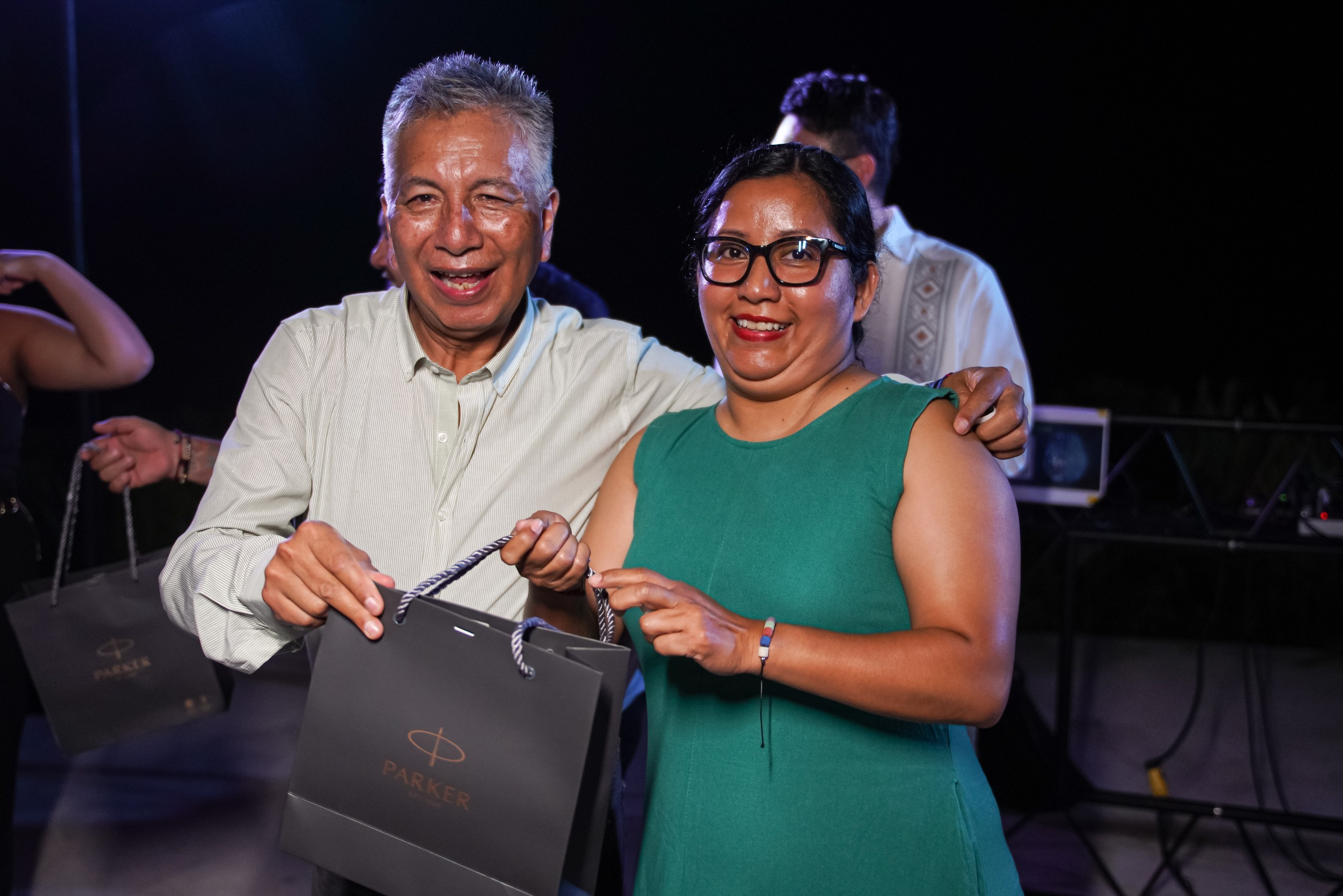 Professionals engaged in conversation at event reception.
