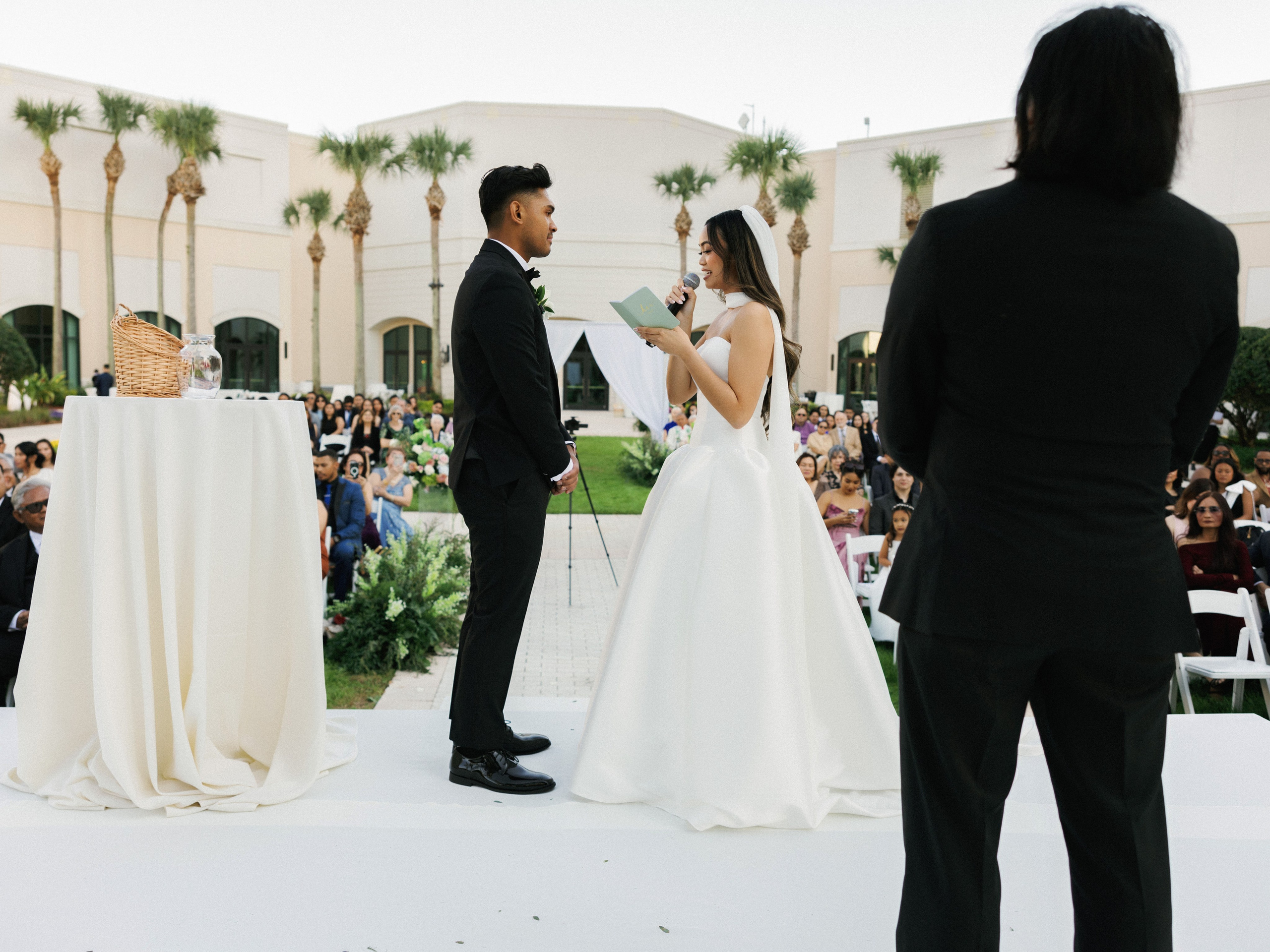 Bride and groom exchanging vows during an outdoor wedding ceremony