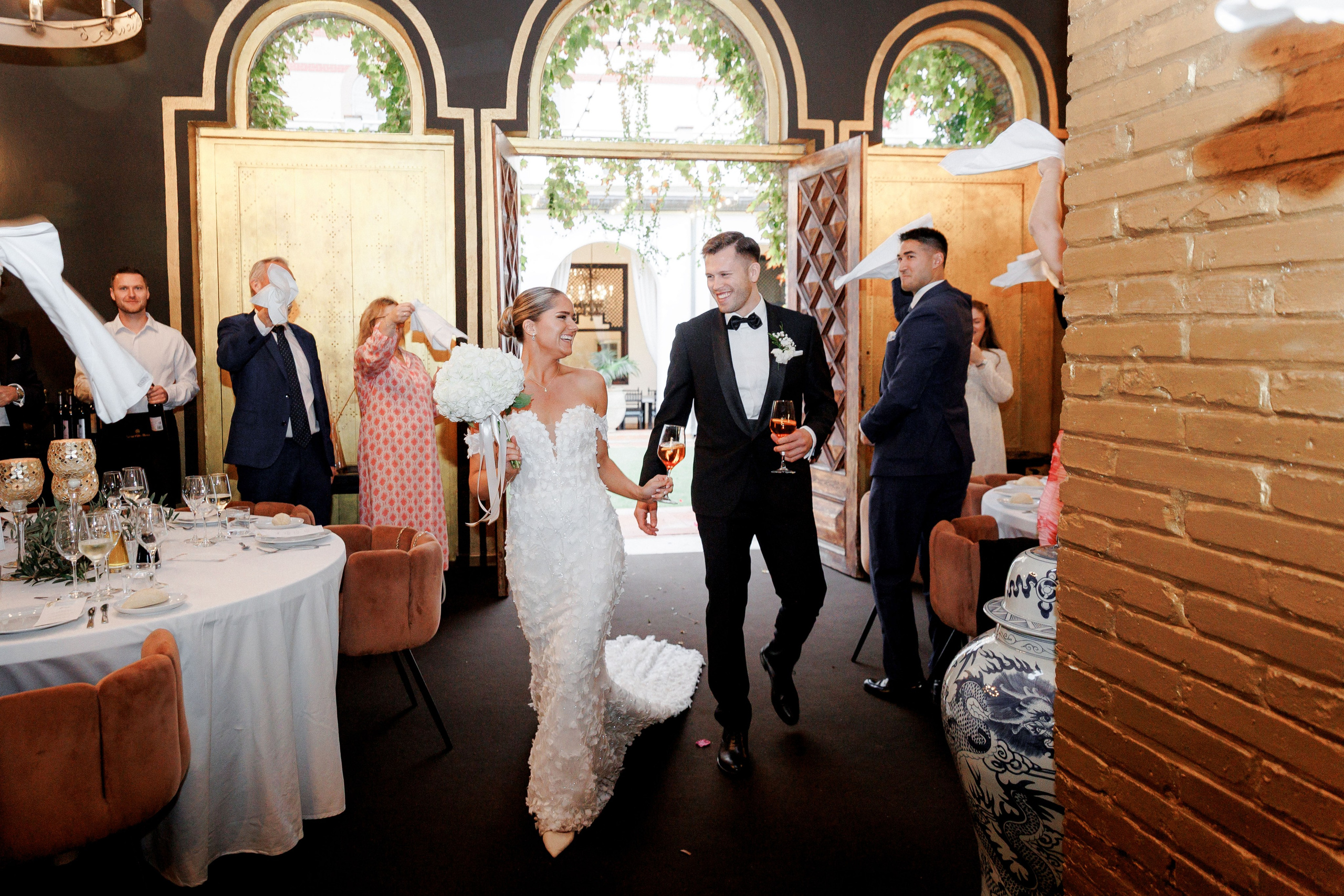 The bride and groom enter the dinner hall to celebrate their wedding in Barcelona. 