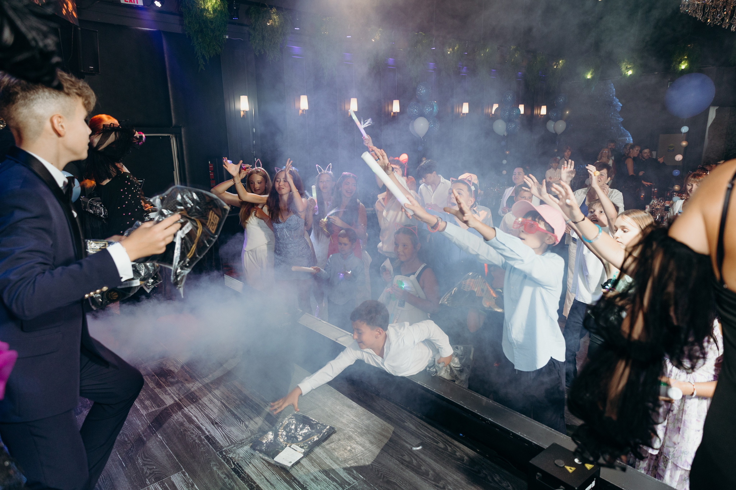 Bar Mitzvah party with dancing guests and vibrant atmosphere. Bat Mitzvah celebration with friends and fun candid moments. Kids and guests dancing at Bar Mitzvah event in Toronto