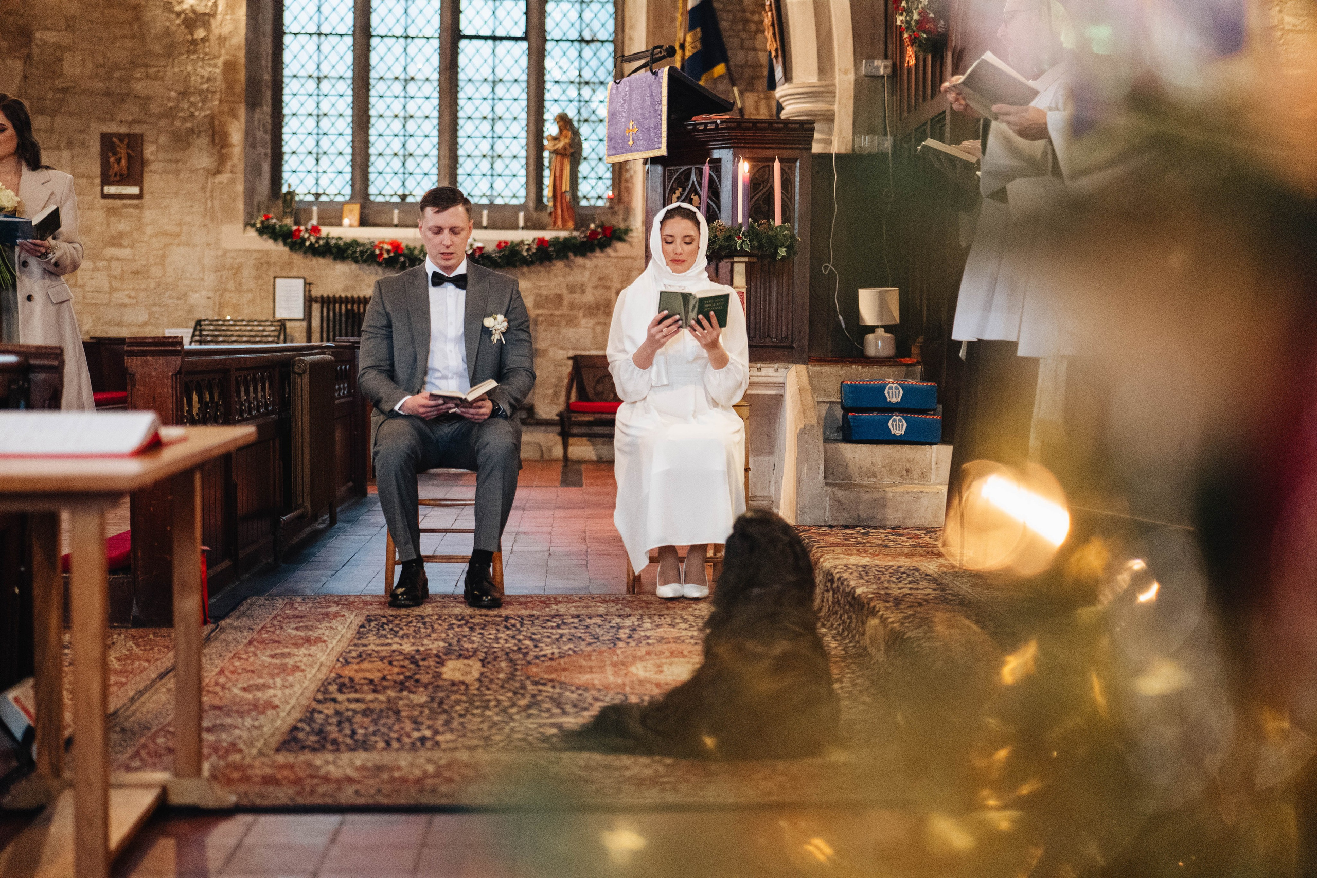 ceremony in church, bride and groom sitting