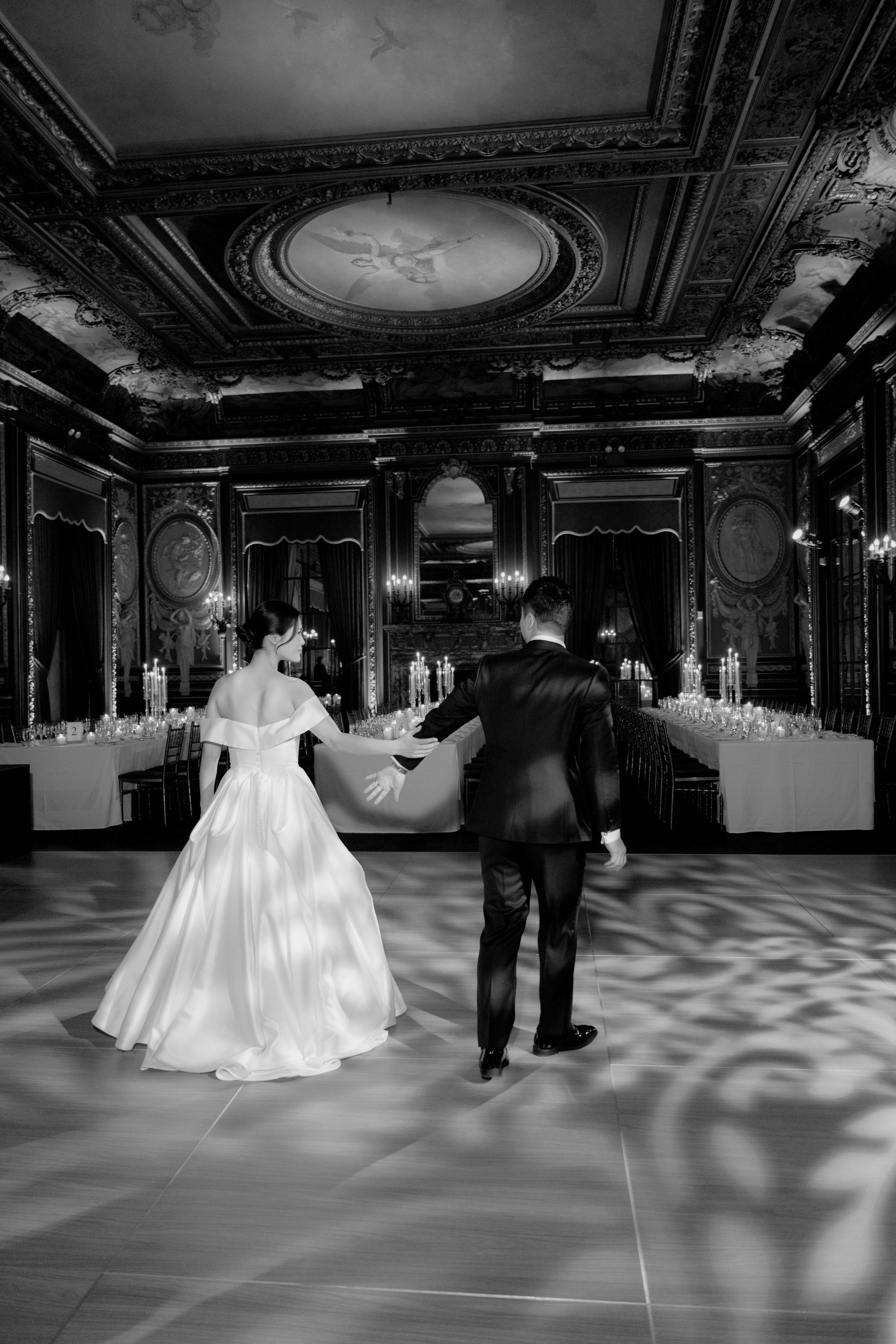 a bride and groom dancing in the ballroom