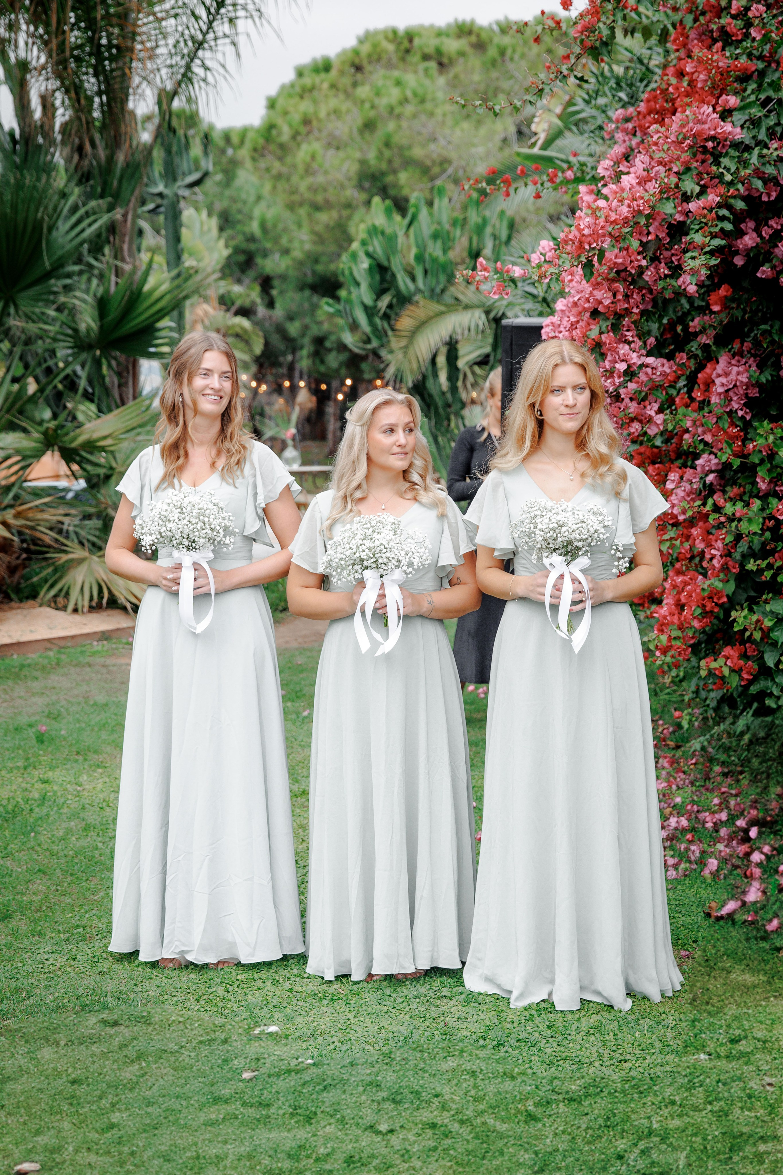 Bridesmaids in matching dresses laugh together before the ceremony, adding joy and excitement to the wedding day in Barcelona.