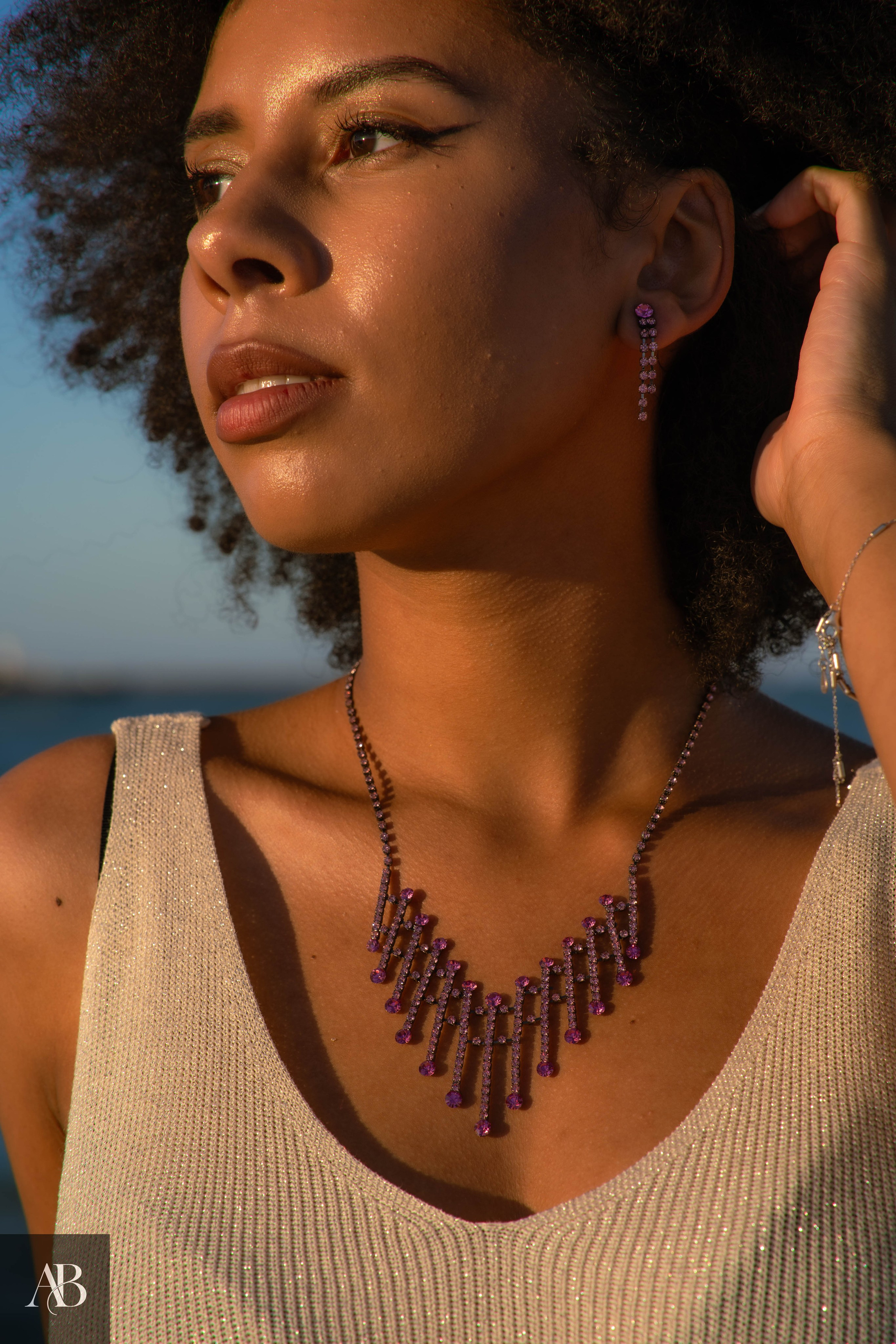 Jewelry product photography in Constanța, Romania featuring a purple gemstone necklace and matching earrings.