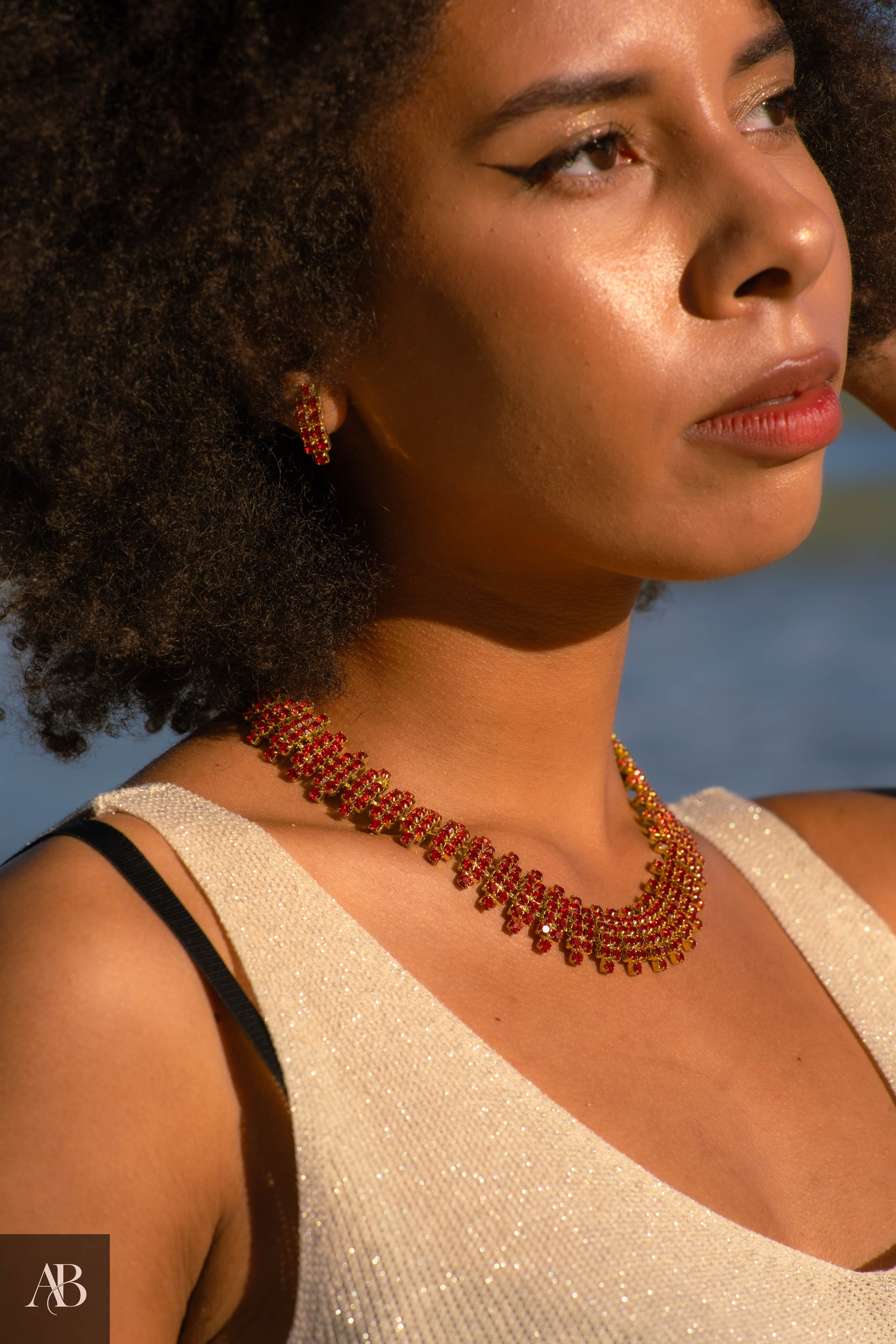 Jewelry product photography in Constanța, Romania featuring a red gemstone necklace and matching earrings.