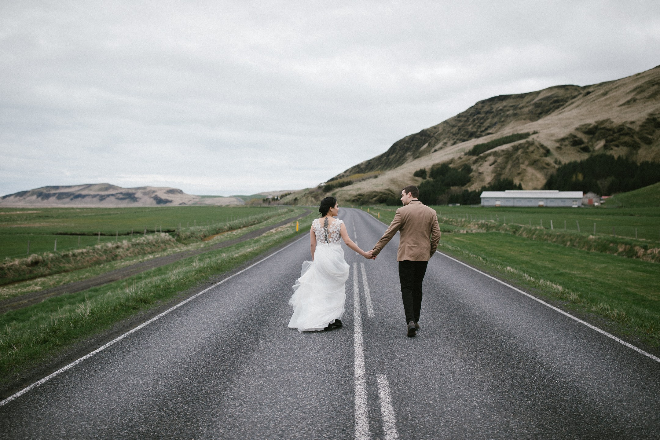 Walking hand in hand through Iceland’s open road and wide landscape