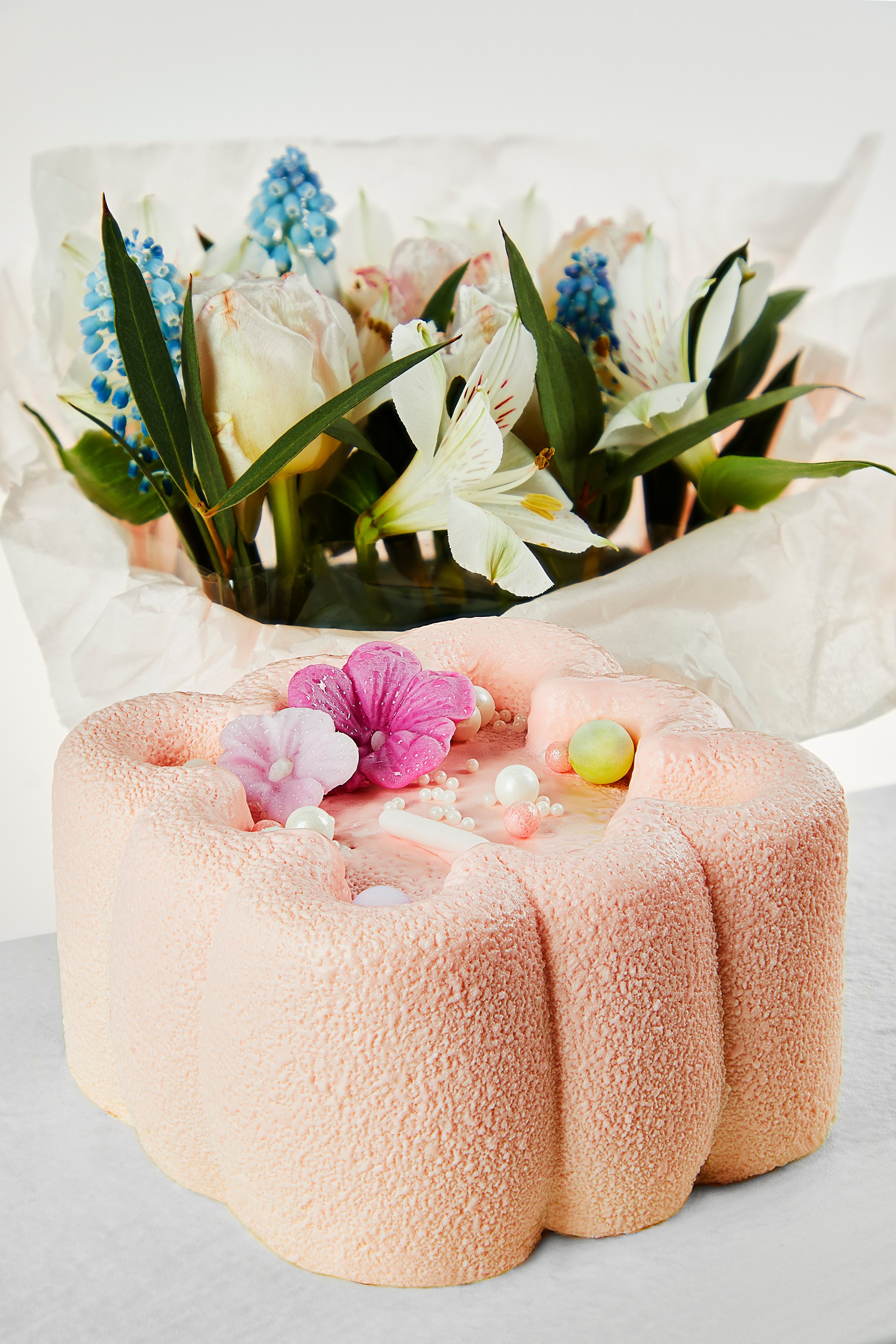 Photographer Roman Djuzev - Pink Cake In Close-up With Flowers In The Background.