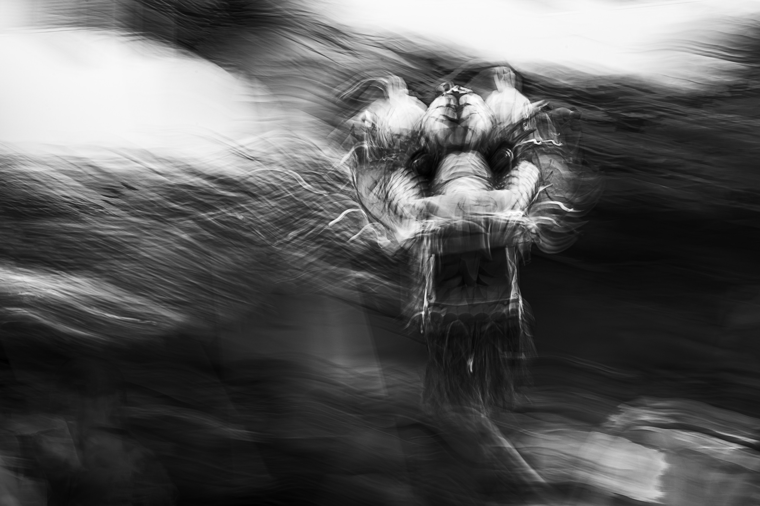 A mesmerizing black-and-white photograph showcasing a blurred and dynamic depiction of a performer during the Monkey King’s Birthday celebration in Singapore. The swirling motion and abstract forms evoke energy and mysticism, capturing the vibrant spirit of the event. This image highlights the photographer’s expertise in creative reportage and event photography, ideal for clients seeking artistic and impactful visual documentation of cultural or corporate celebrations.