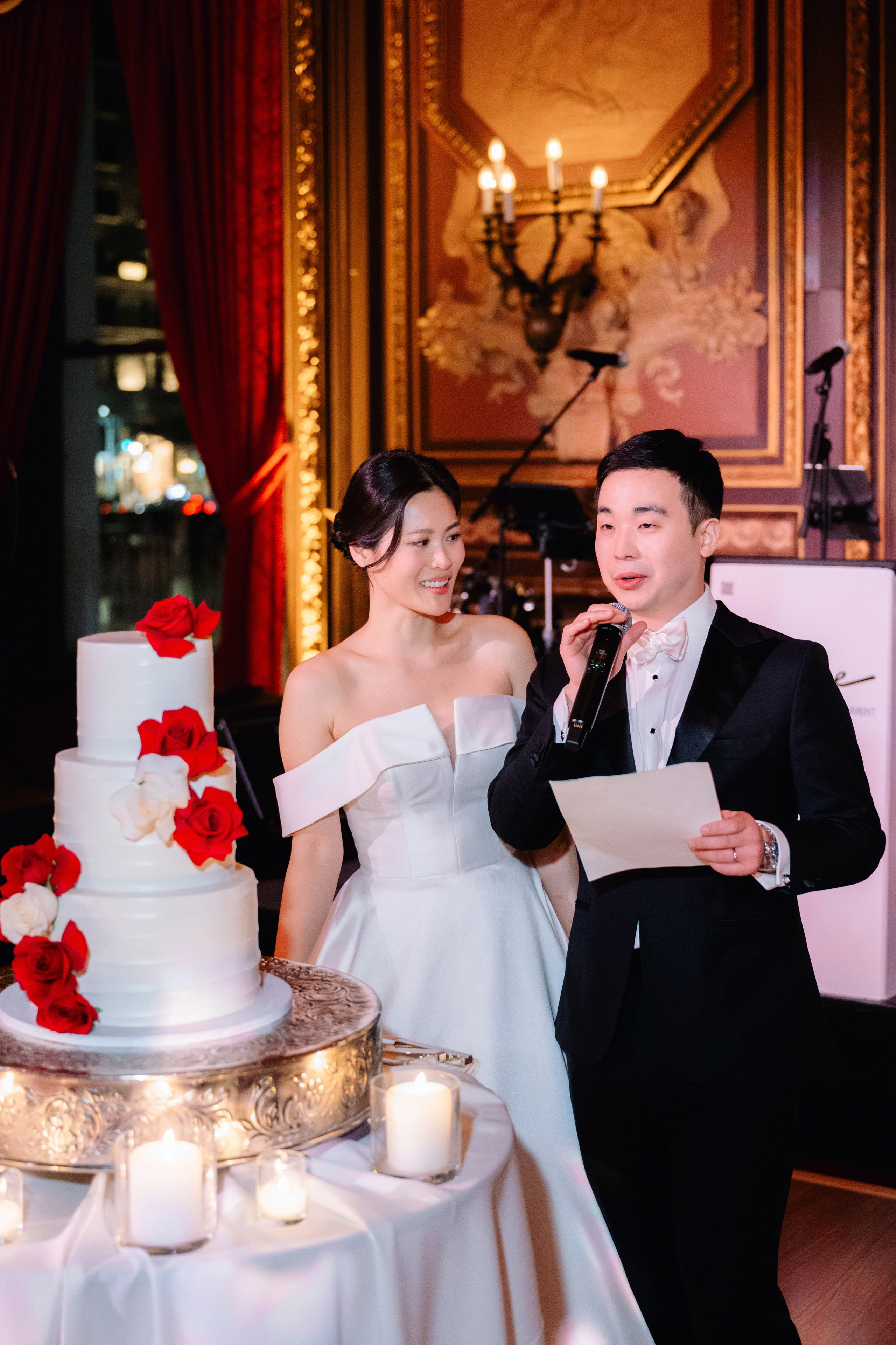 a man and woman are cutting a cake