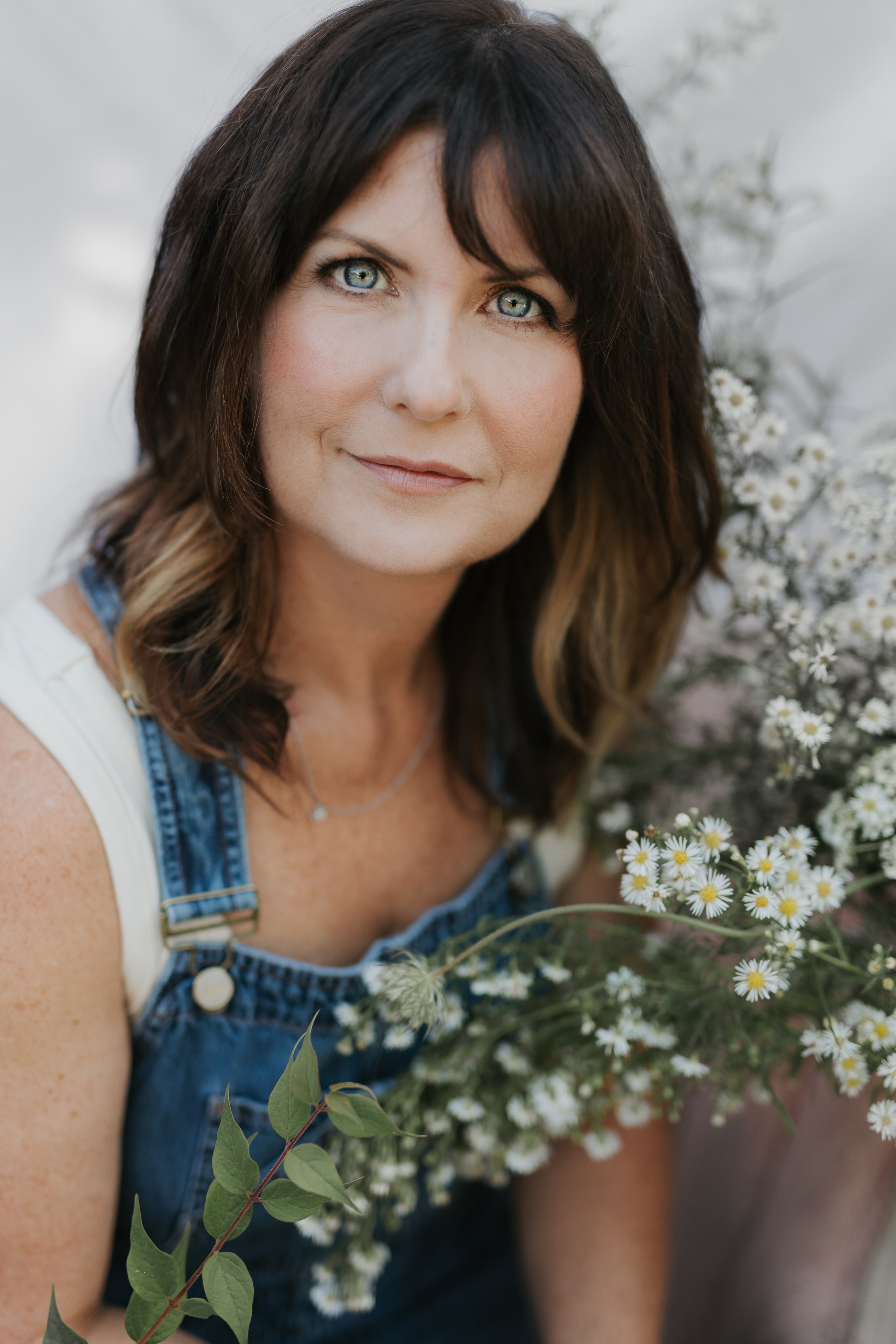Close up of woman surrounded by wildflowers 
