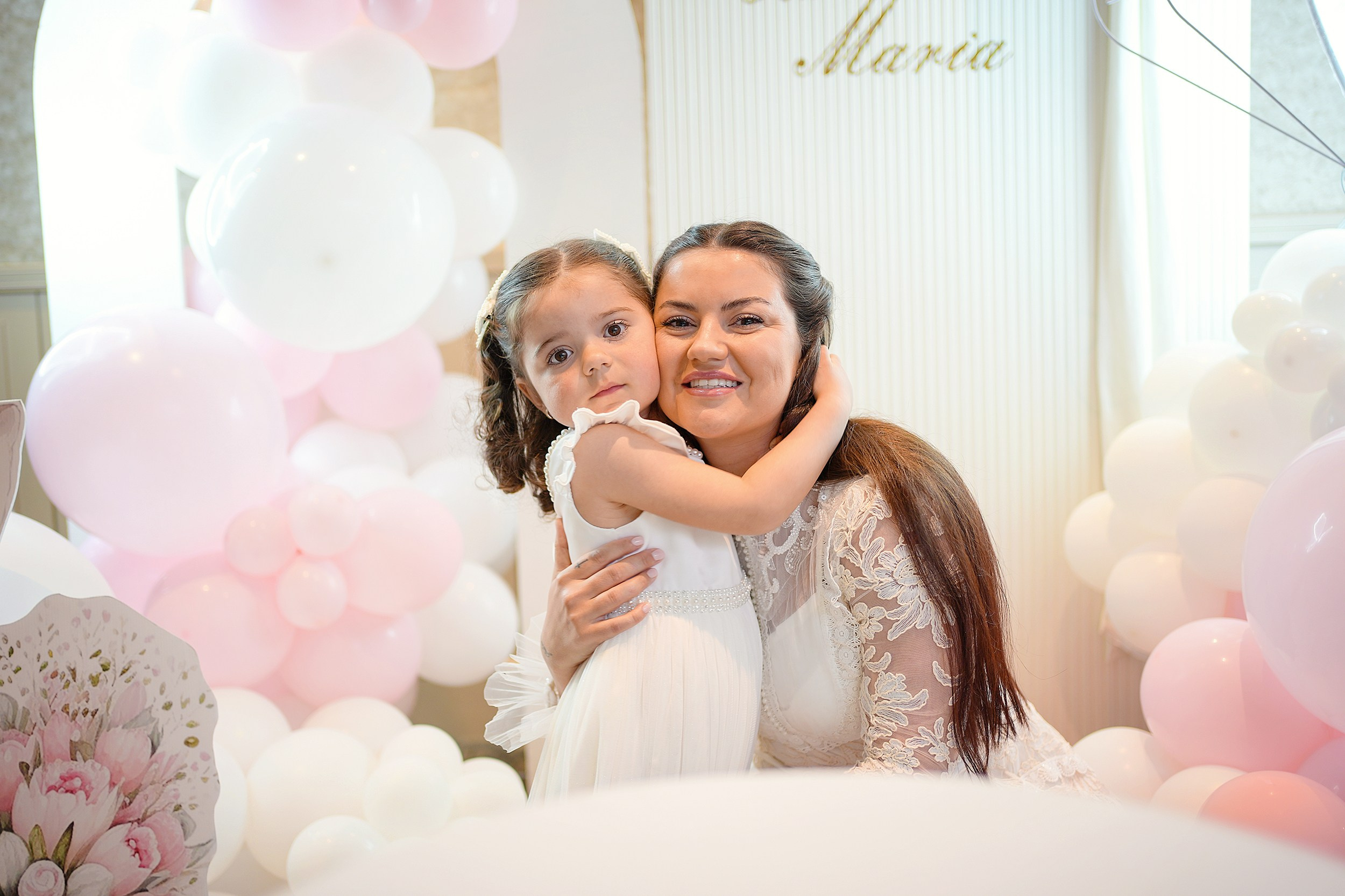 Portrait of a woman and child during baptism.