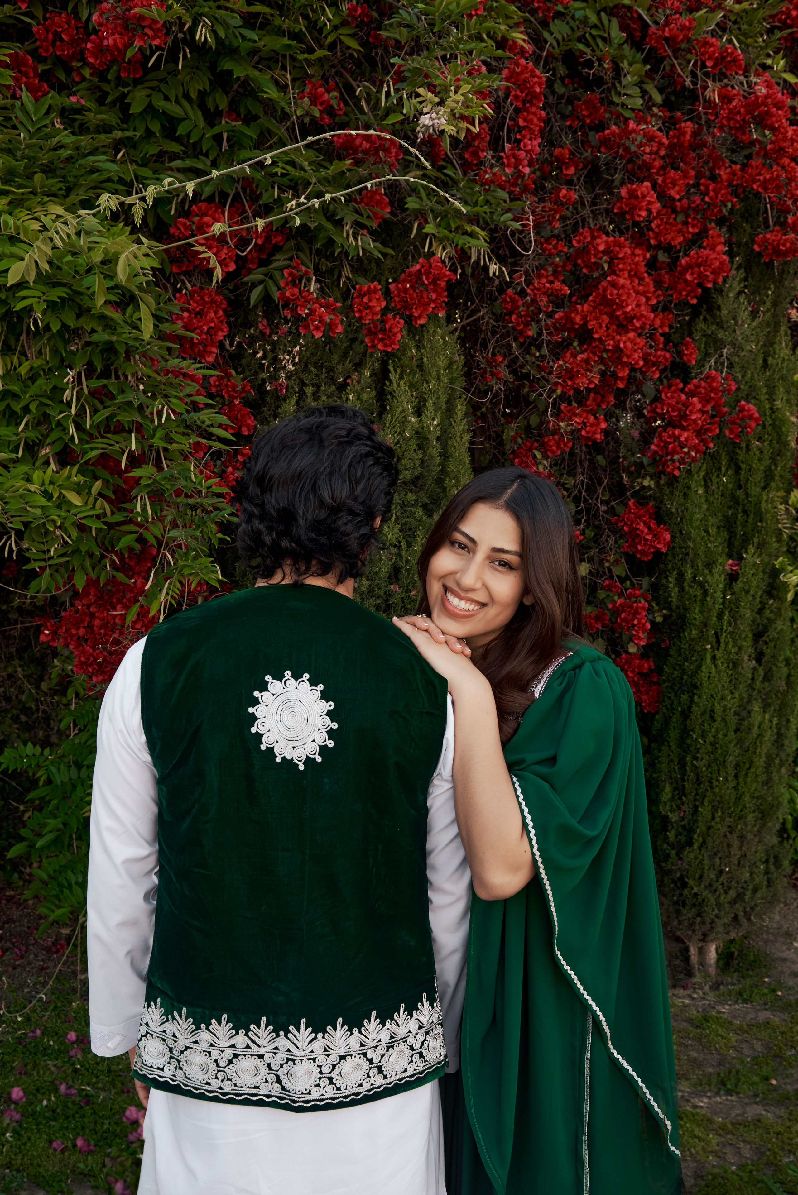 Charming engagement portrait of a couple walking hand-in-hand along a Los Angeles pier