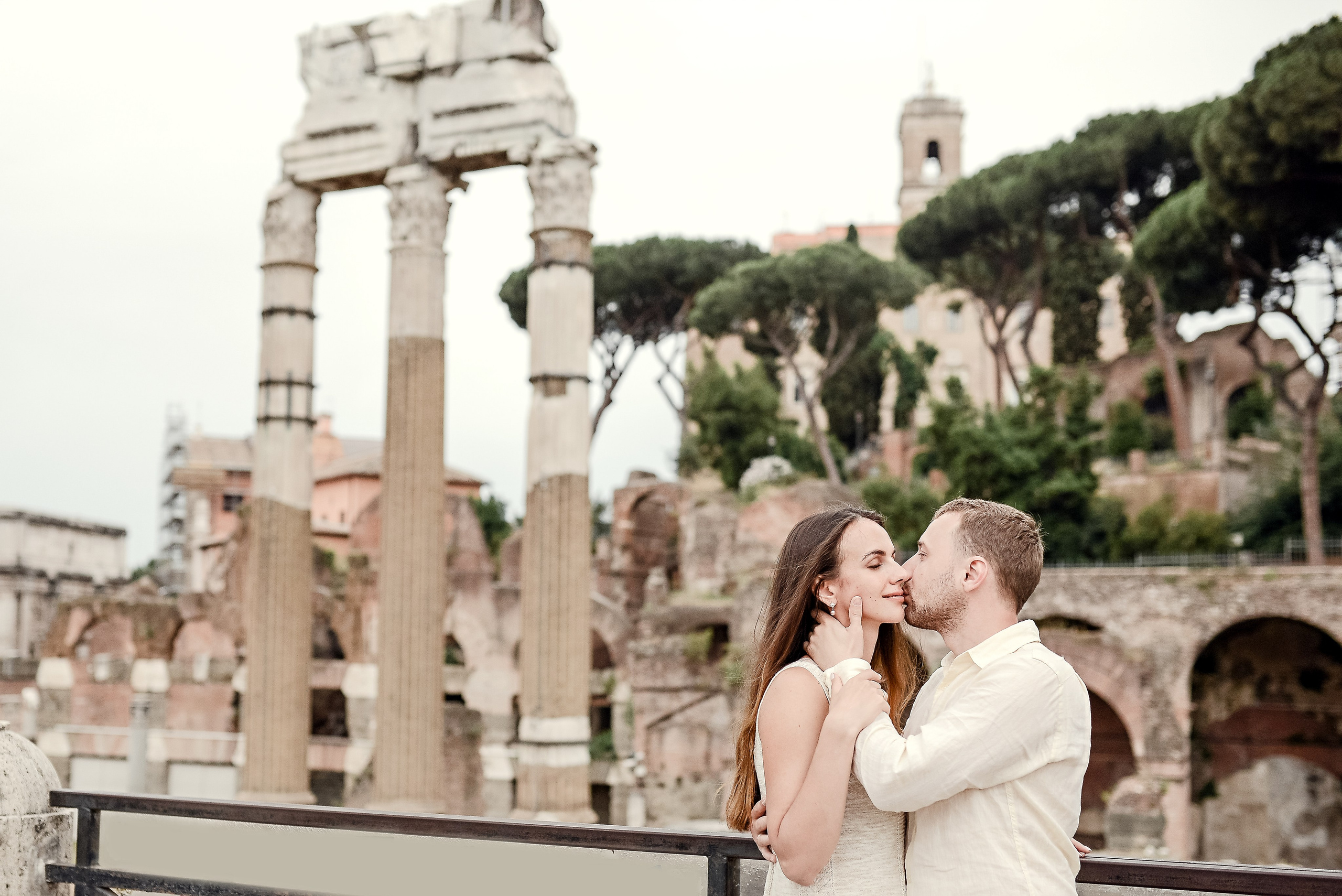 Intimate moment between a couple with the ruins of the Roman Forum in the background