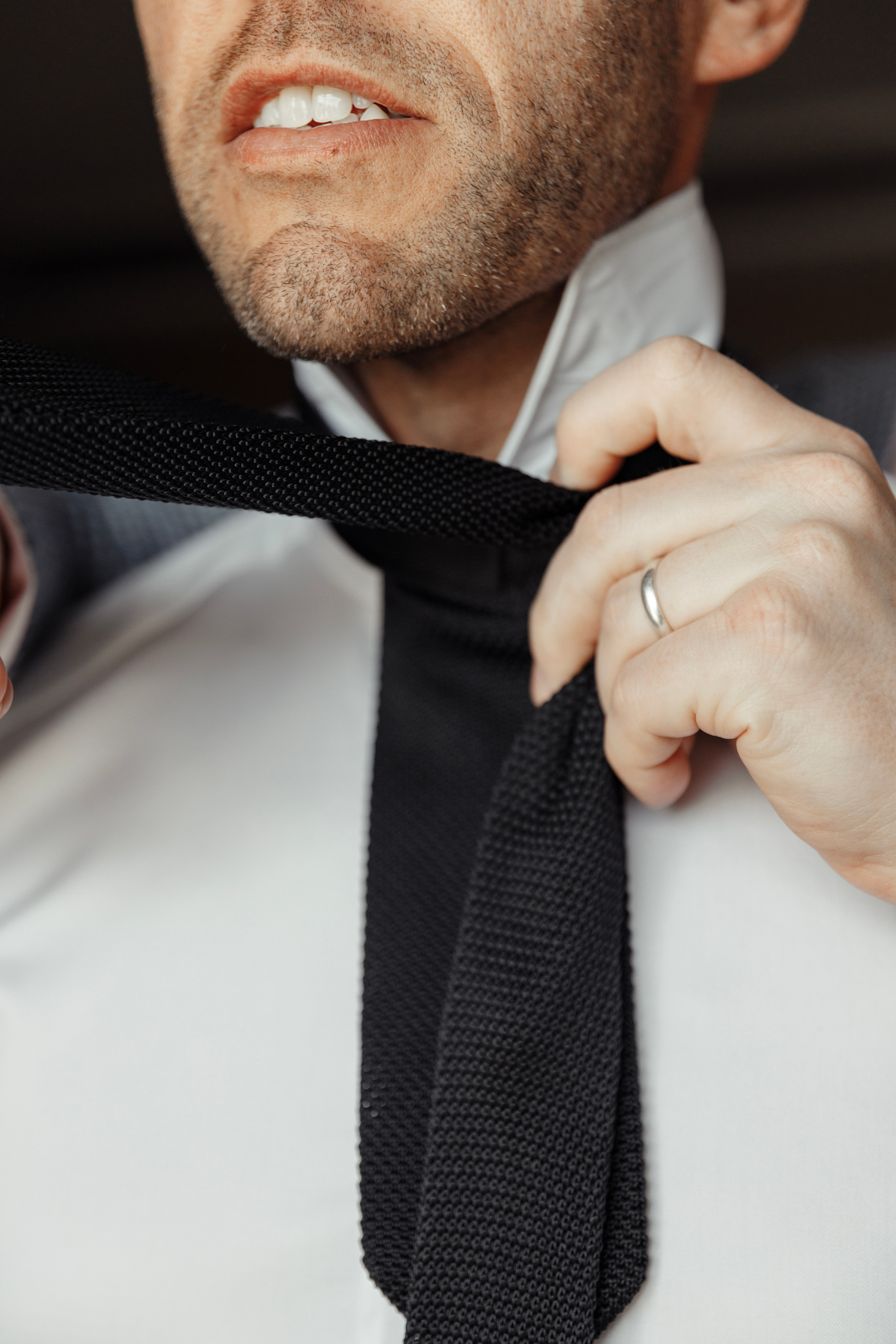 Groom's best man is adjusting a tie in a luxurious hotel room in Rhodes, Greece, 