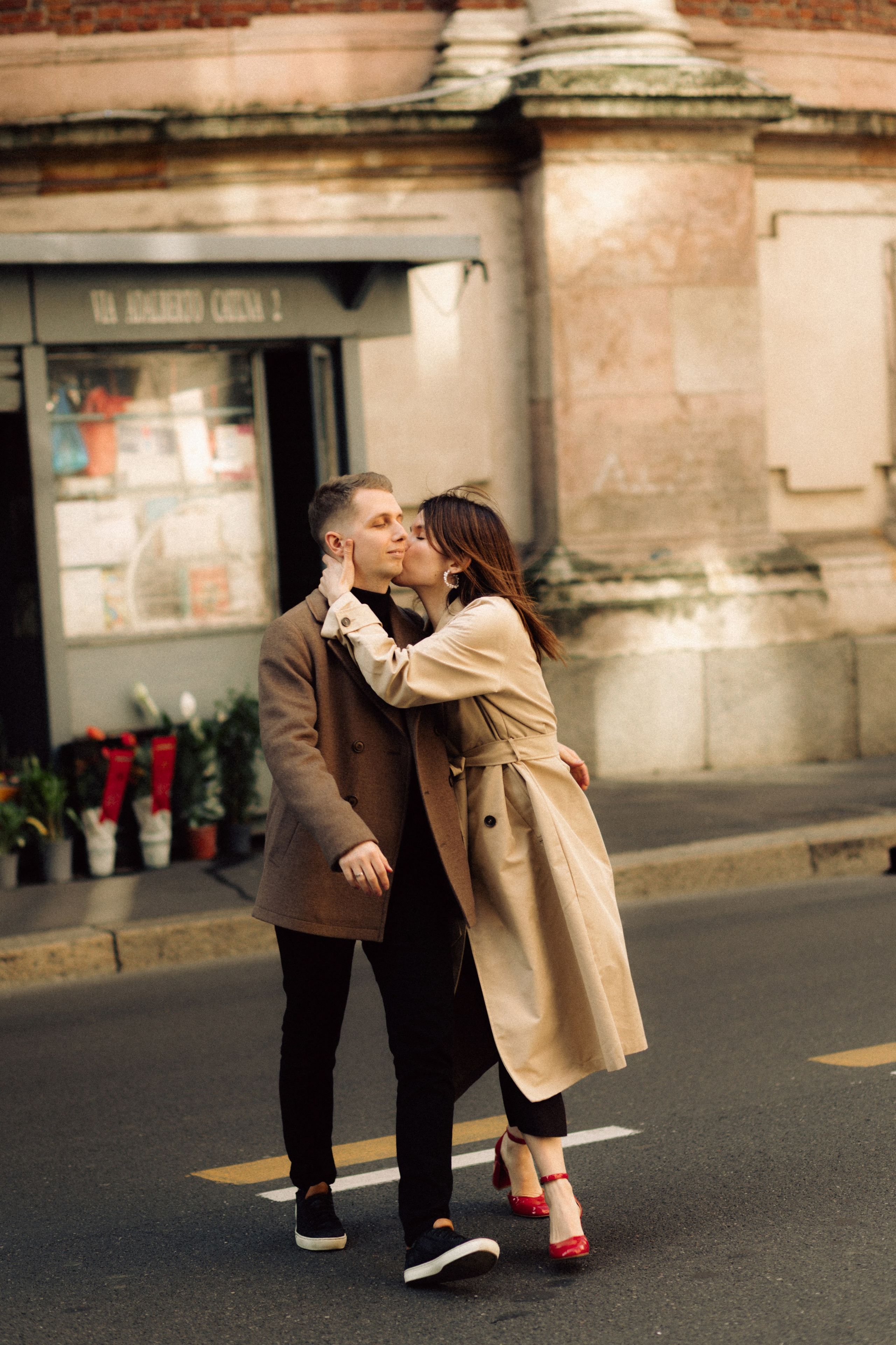 Dynamic couple walking through the streets of Milan during their love story session