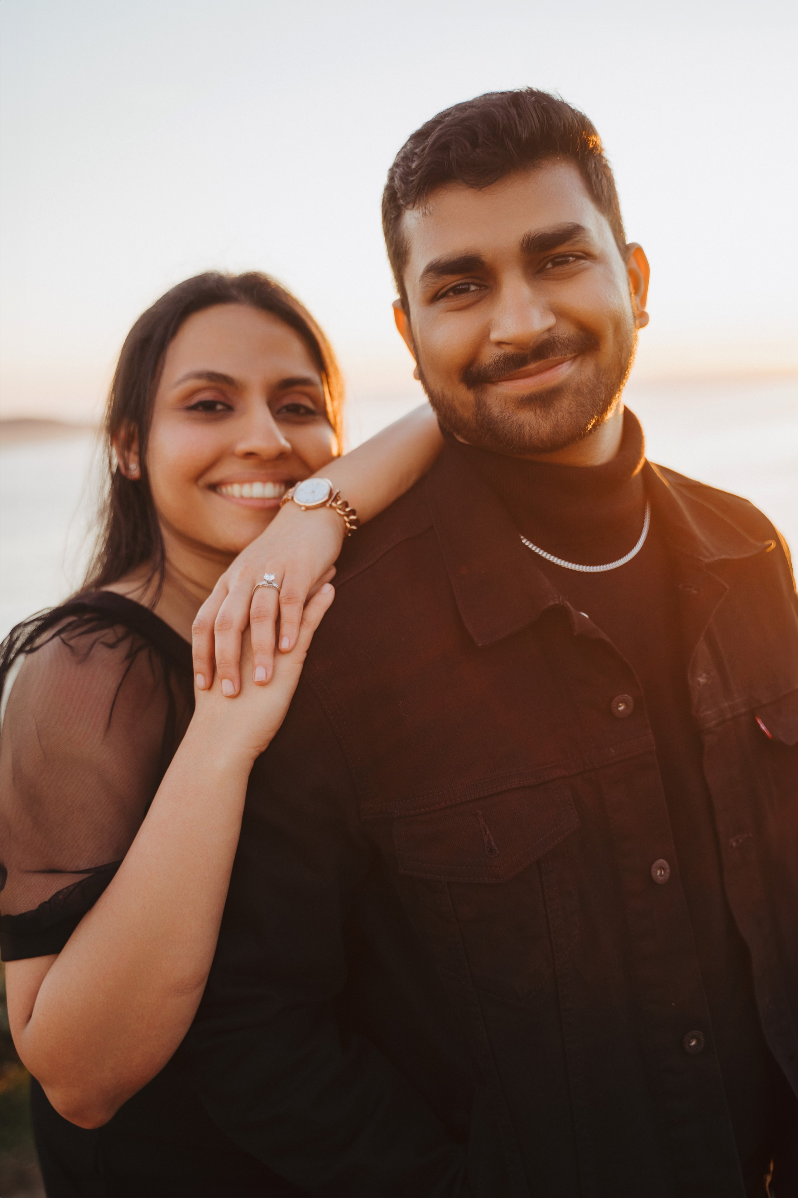 Proposal.  Overlooking the golden San Franisco Bridge sunset with a couple. Photographer Video. 