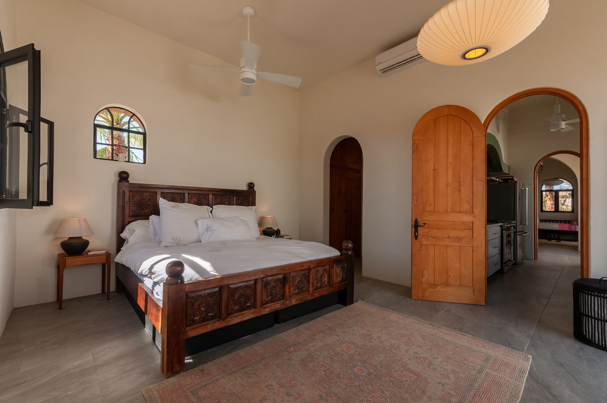 Master bedroom in Todos Santos Baja California Sur – natural light, ceiling fan and warm minimalist interior design