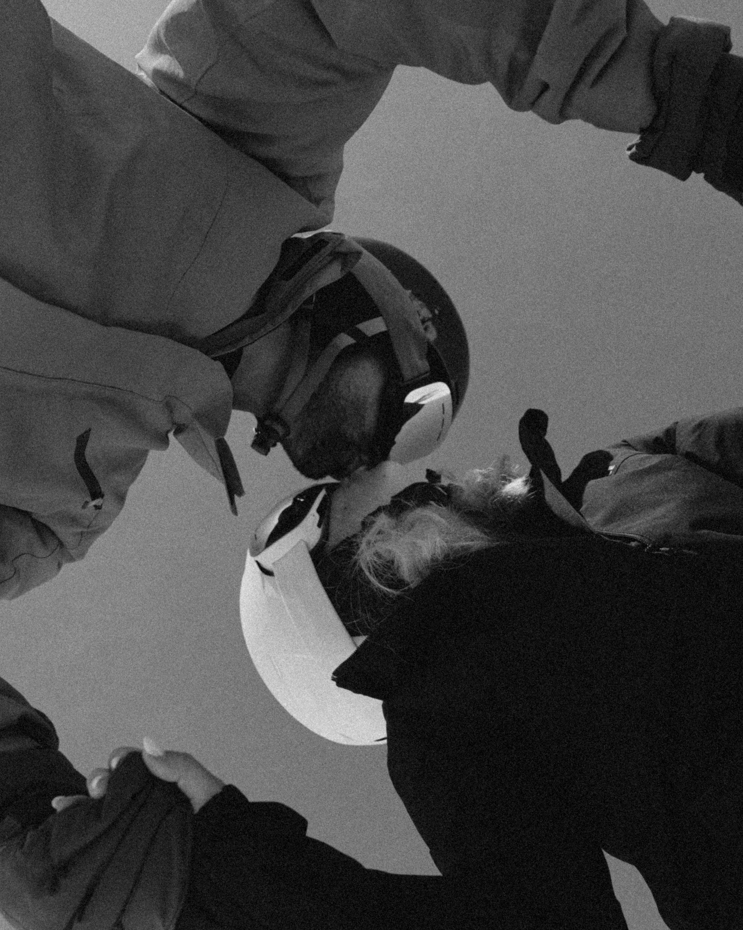 Couple holding hands on snowboards during winter engagement shoot in Gudauri
