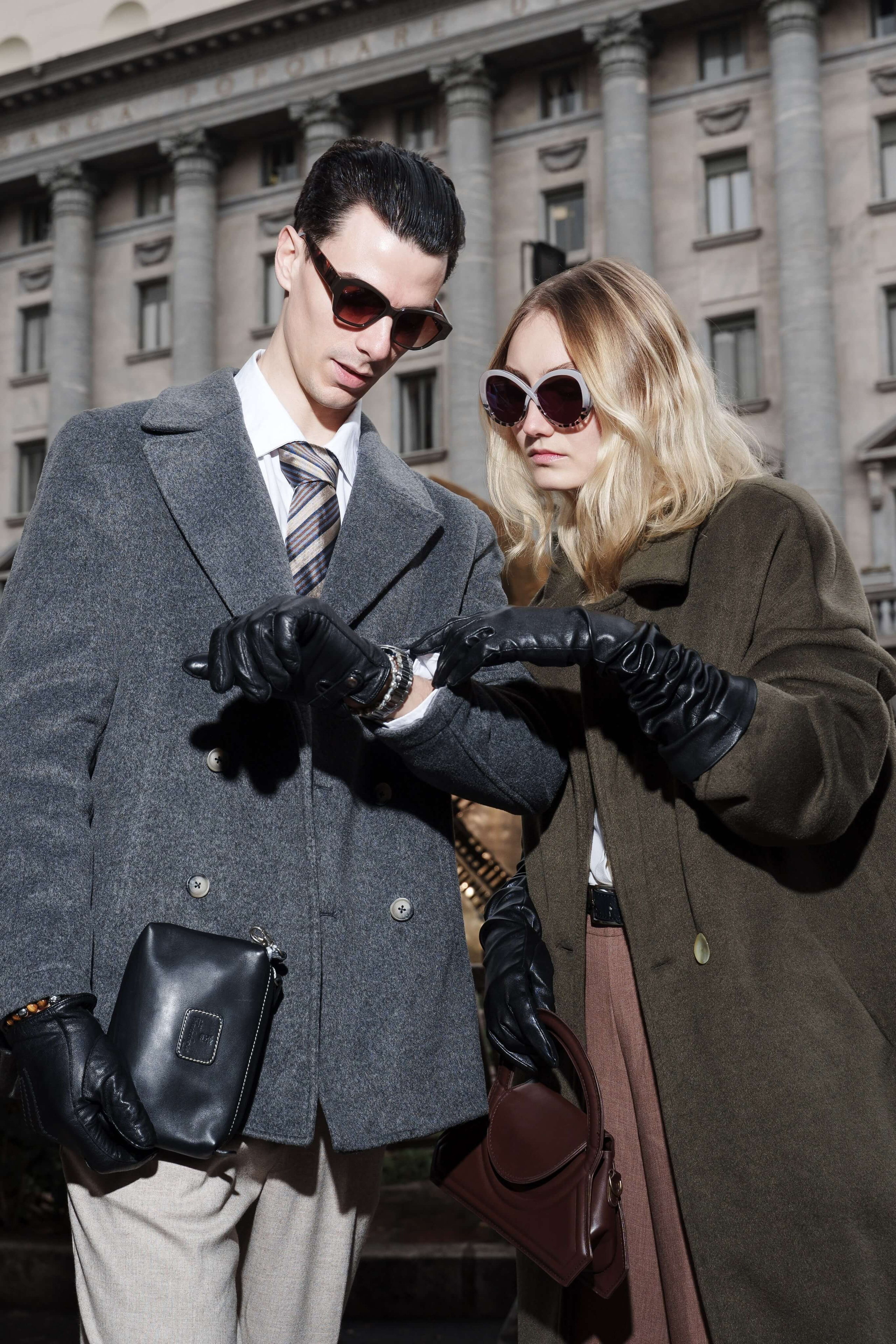 Fashion couple examining a watch together in front of a historic building in Milan