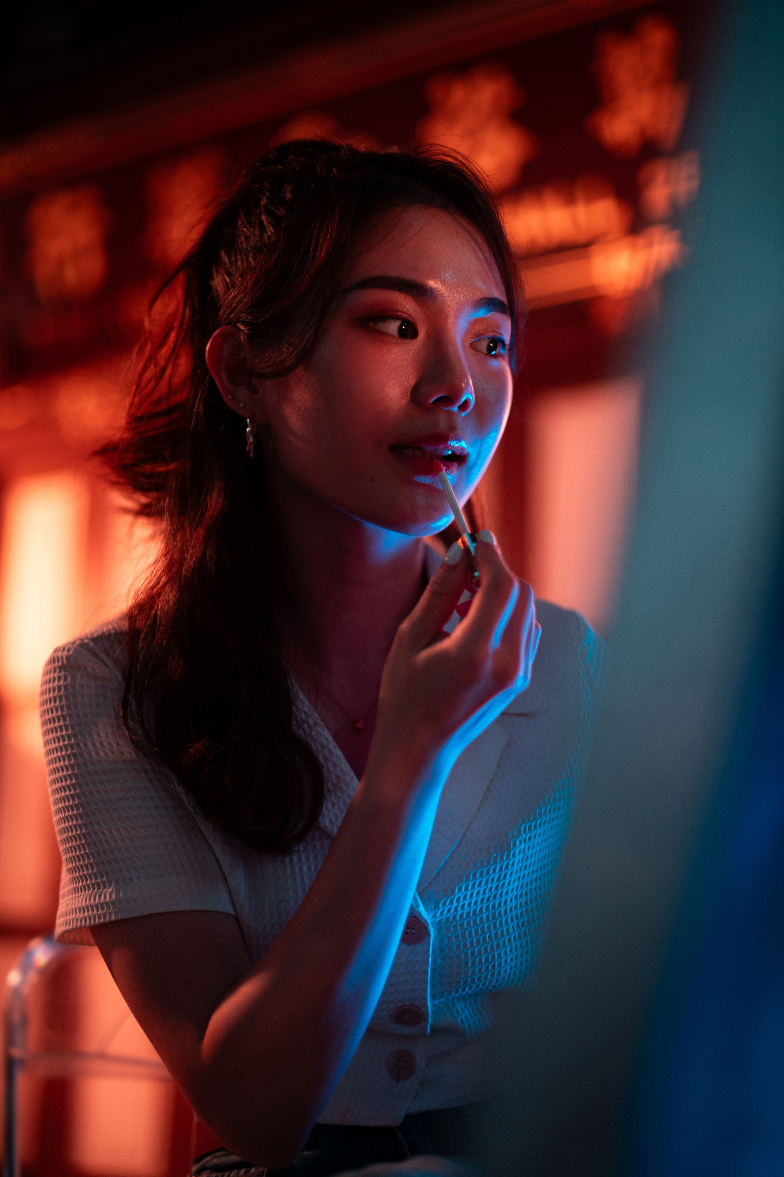 Singapore urban nightscape featuring a prominent street light casting dramatic shadows on a busy city street. Captured by a freelance photographer, this creative editorial shot highlights modern street photography and dynamic urban lighting.