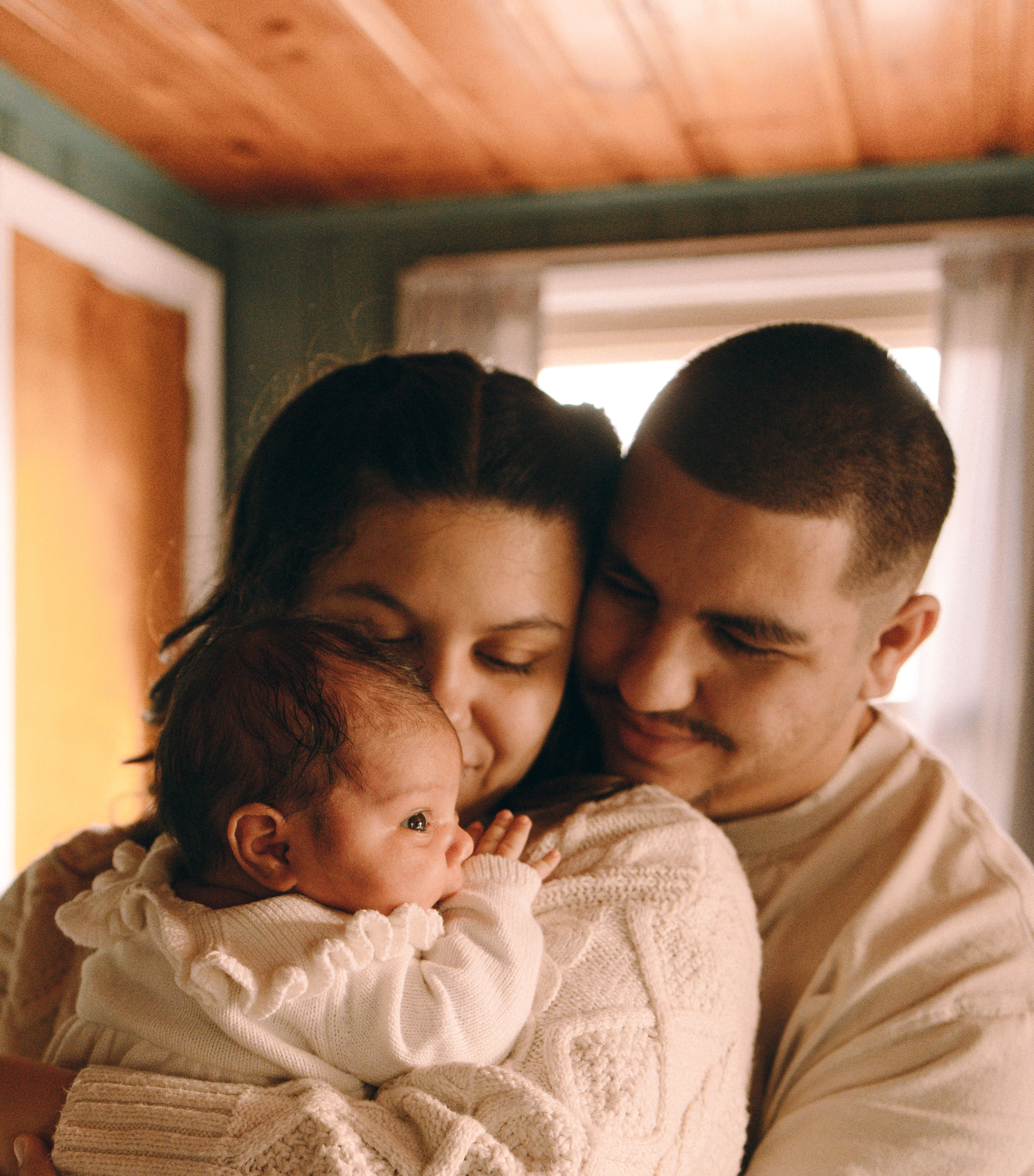 Mom and dad looking ate the newborn little daughter Philly family photographer