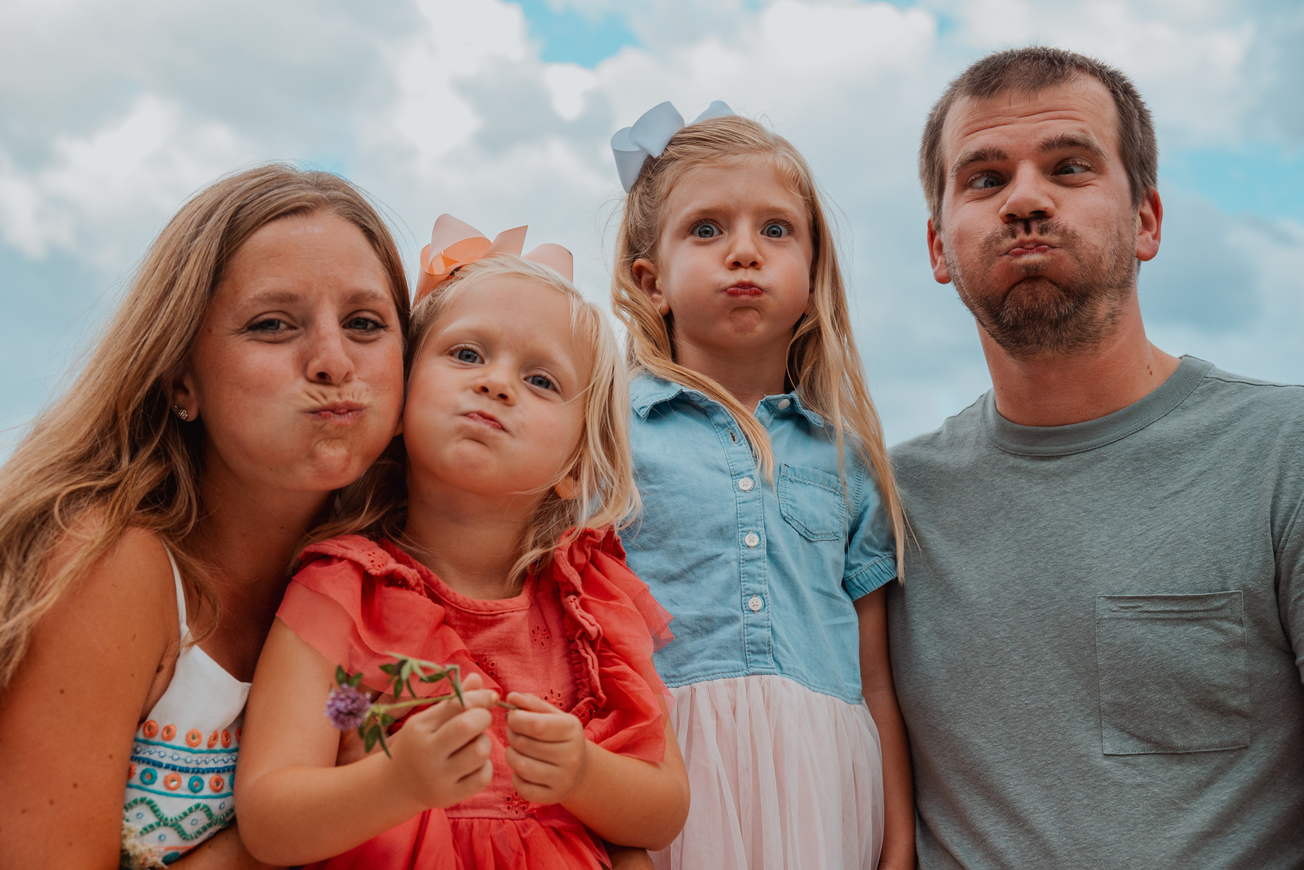 Happy family of four during outdoor sunset session, affordable Green Bay family photographer.