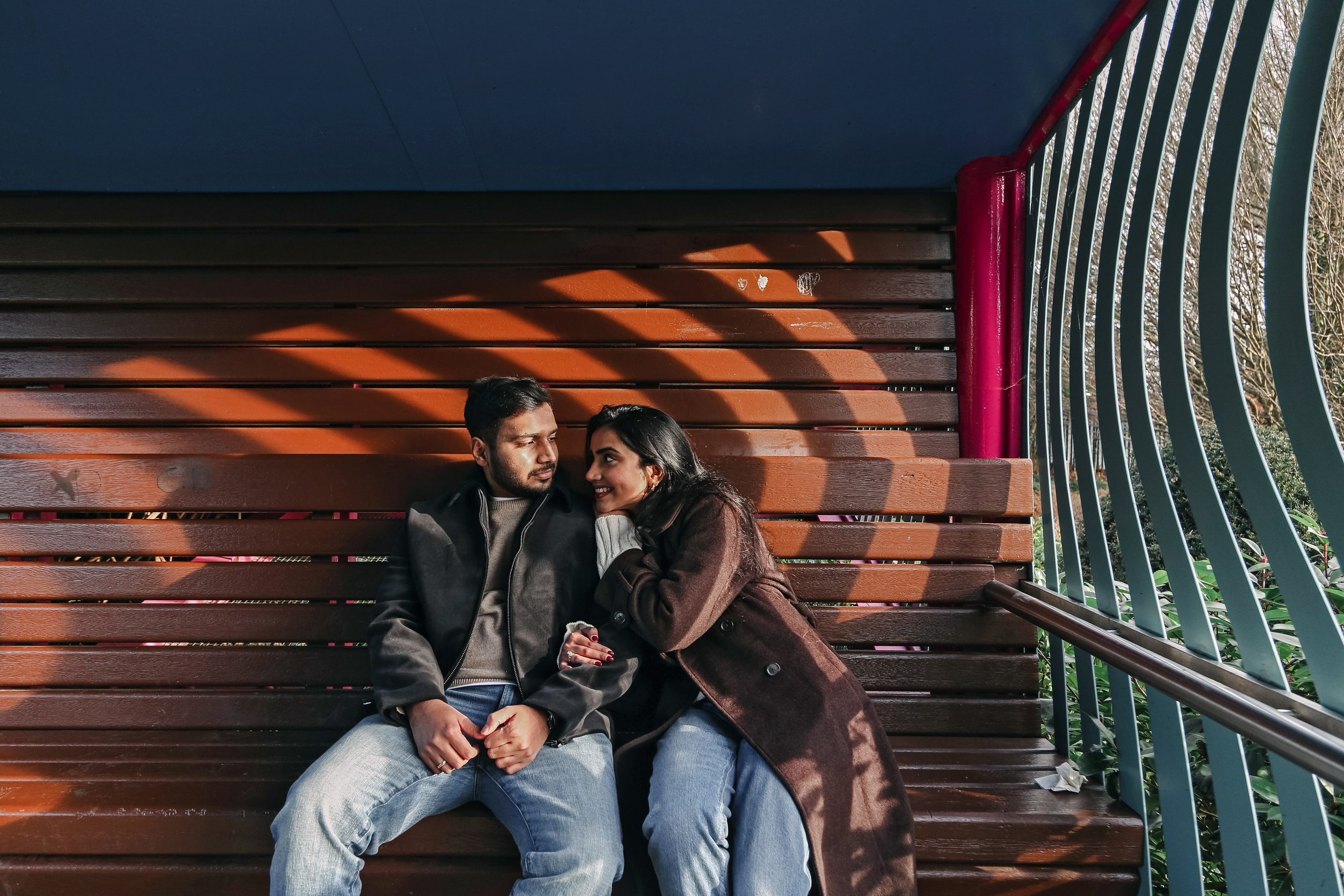 A relaxed moment of closeness under gentle light, capturing warmth, comfort, and quiet conversation.