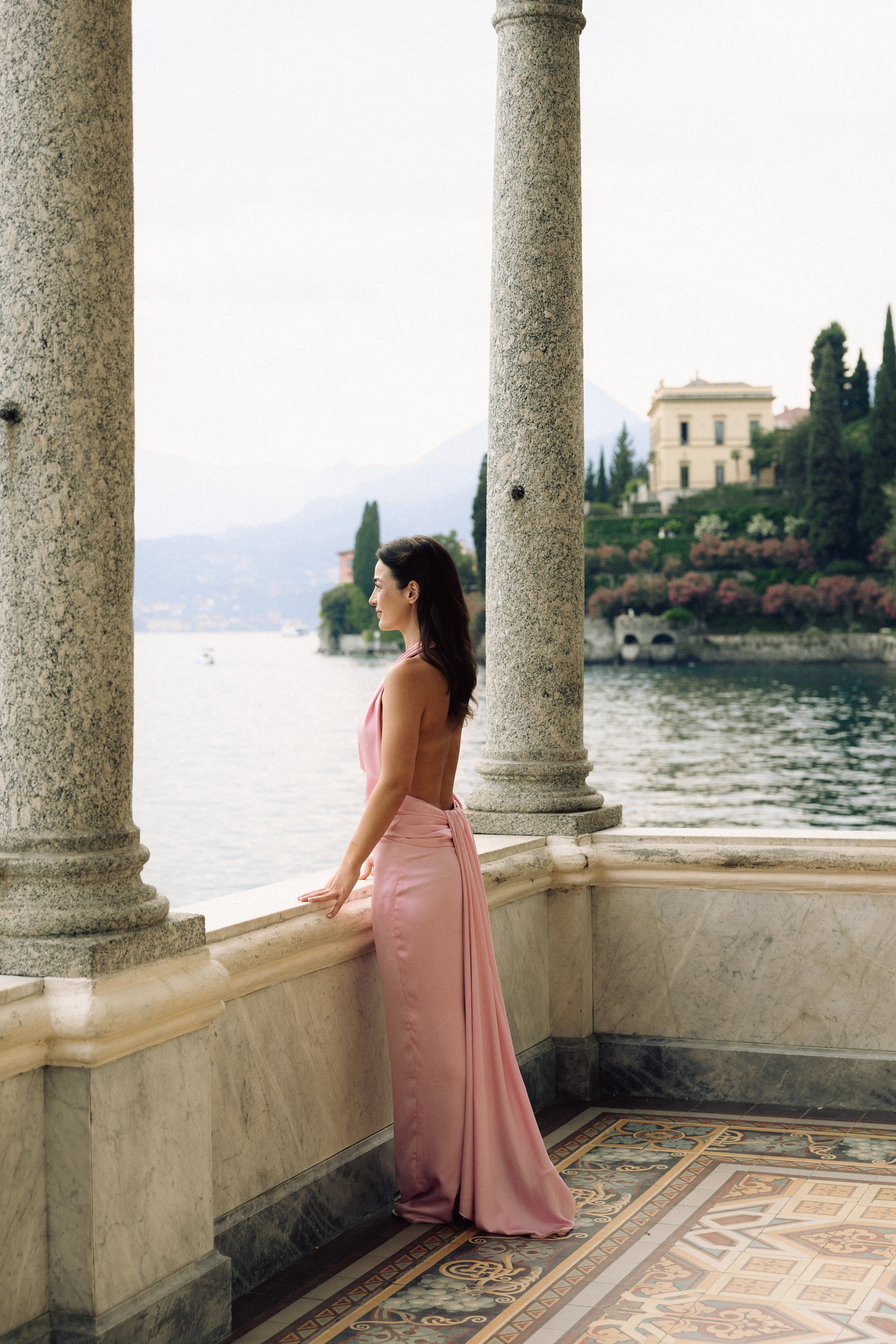 Woman standing near Villa Monastero on Lake Como during a romantic proposal